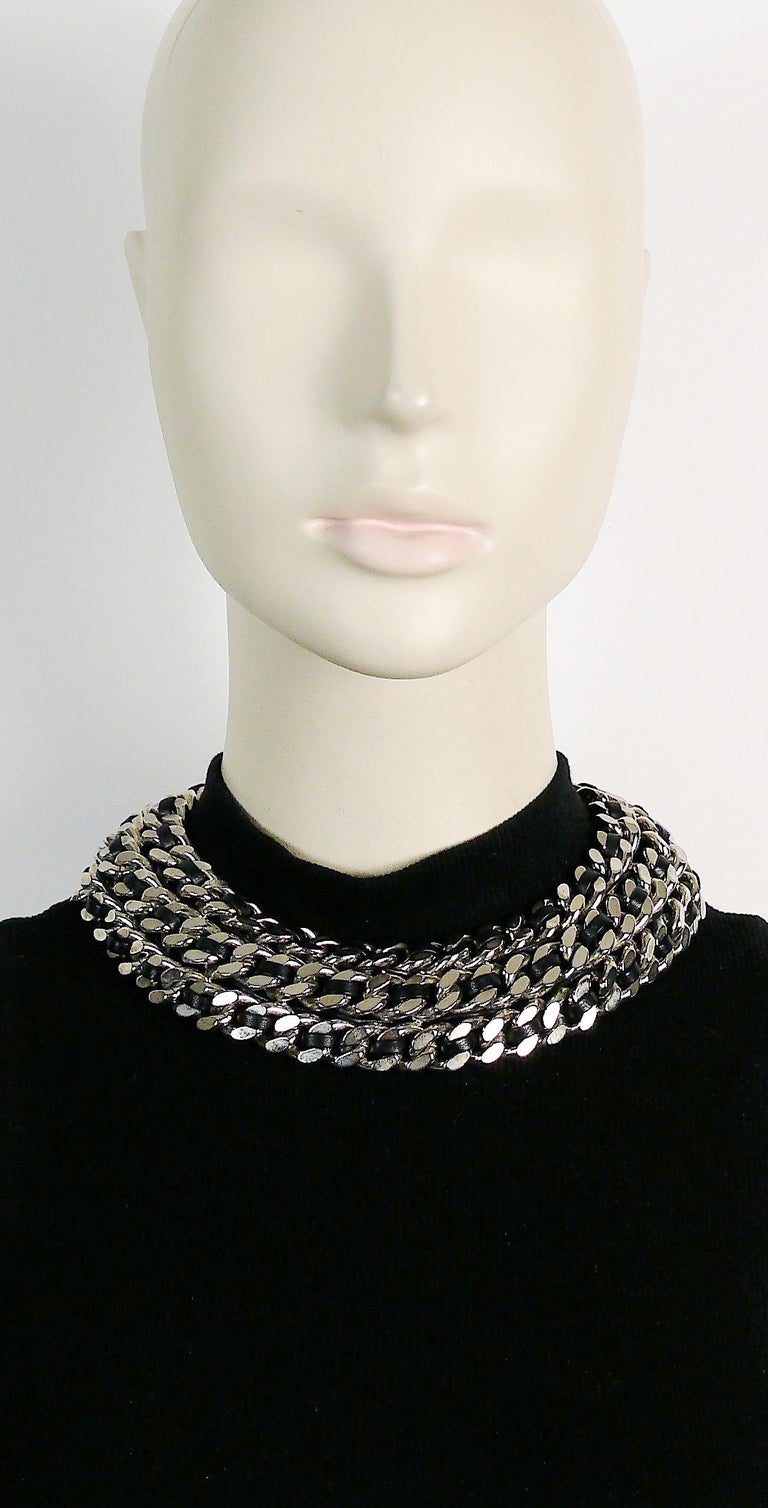 SAINT LAURENT chunky three strand palladium toned curb chain choker necklace with intertwined black leather.

Embossed SAINT LAURENT Paris.

Indicative measurements : inner circumference approx. 34.56 cm (13.61 inches) /  total diameter approx. 18.5