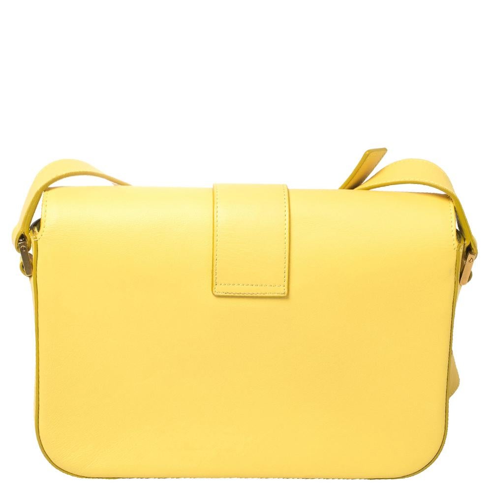 This elegant yellow bag from Saint Laurent is ideal for everyday use. Crafted from leather, the bag is detailed with a gold-tone 'Y' motif snap closure and an adjustable shoulder strap. It opens to a spacious suede interior that is perfectly sized