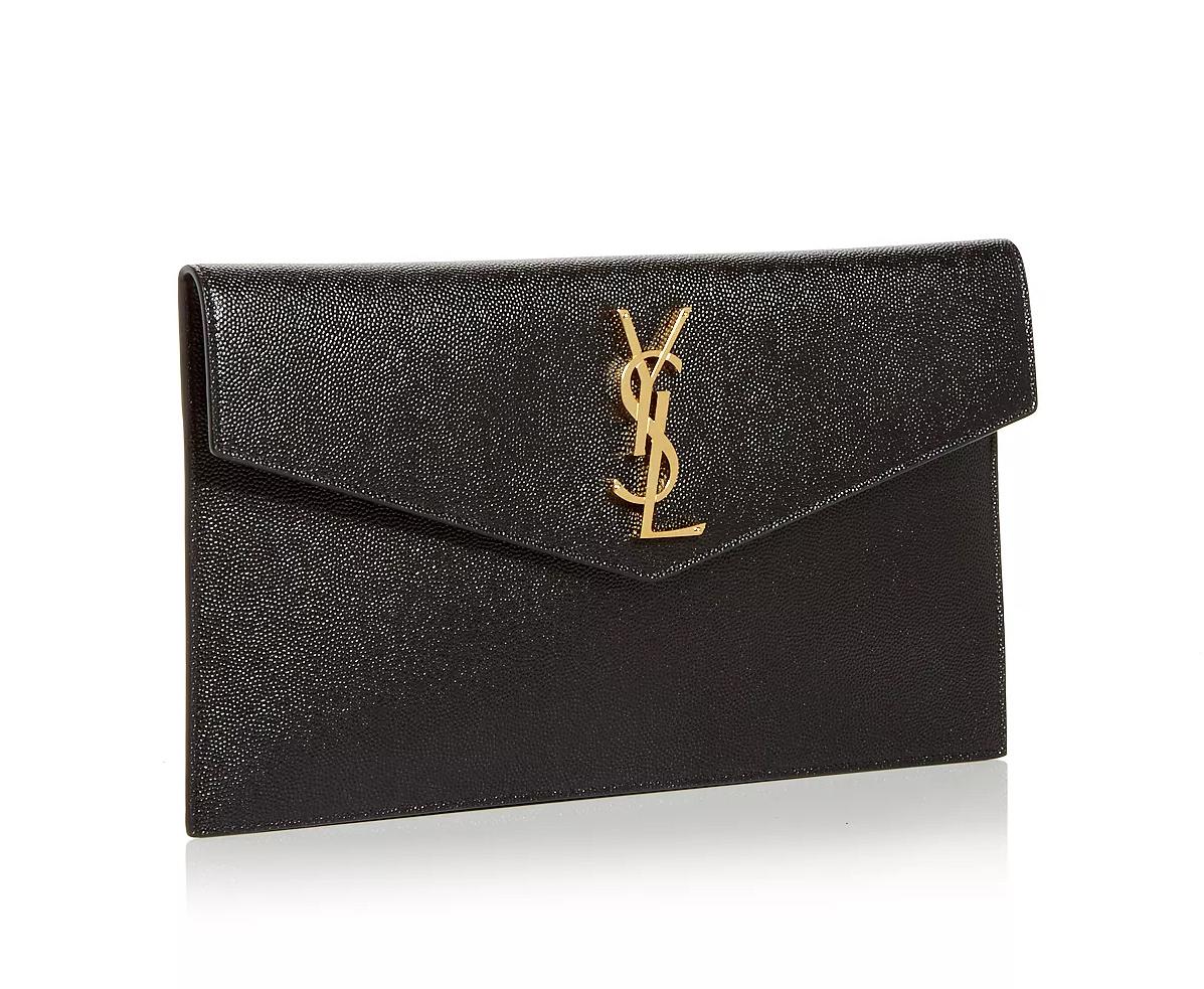 Saint Laurent black grain de poudre leather pouch/clutch with goldtone logo hardware on flap, fabric lining and magnetic flap closure. In excellent condition - has original Saks 5th Avenue price tag.
Dimensions: 10.75