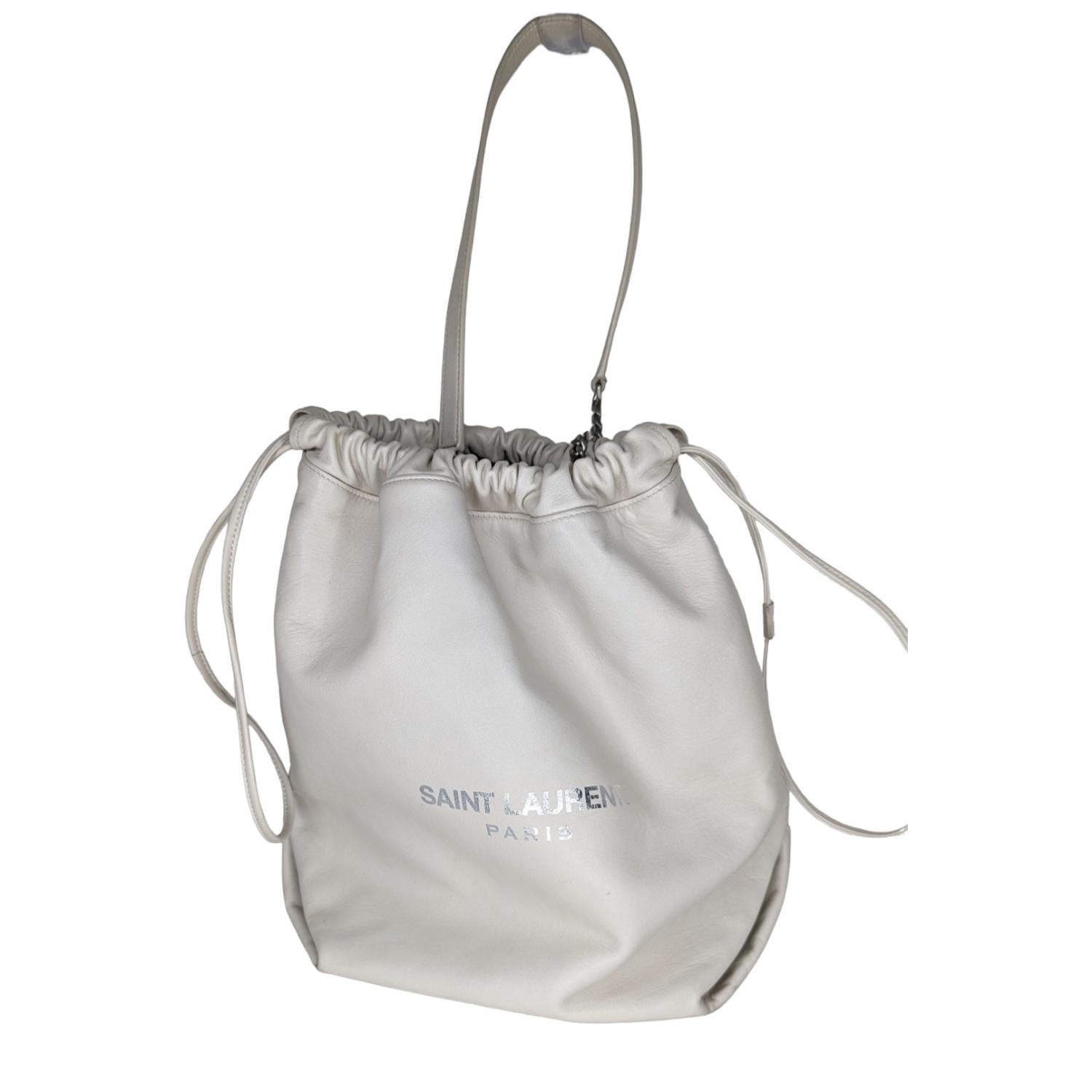 This classic bucket shape is crafted of rich smooth lambskin in off white. The bag features a drawstring top and a chain shoulder strap with a leather shoulder strap. The top opens to a spacious black fabric interior.

Designer: YSL Saint