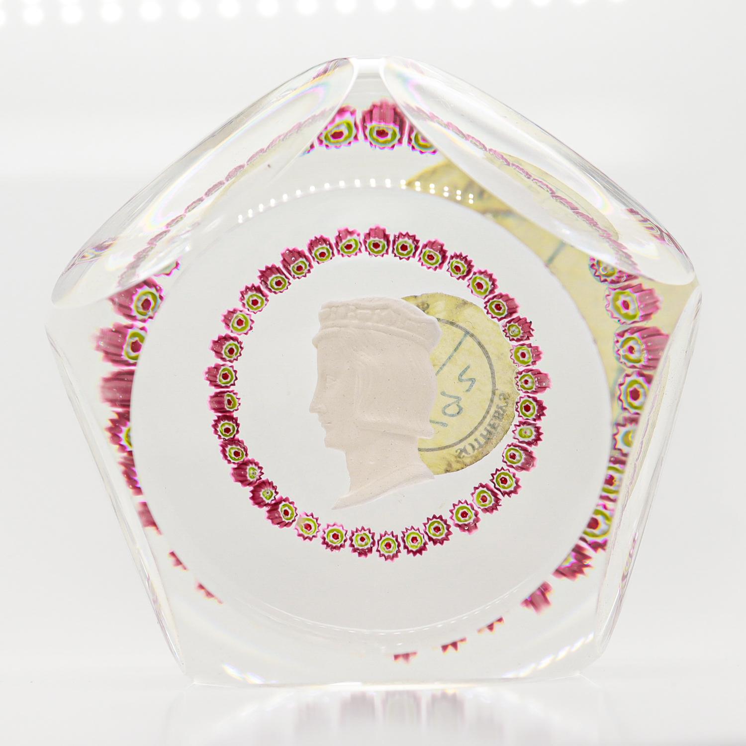 A fine vintage French signed art glass paperweight.

By Saint-Louis.

With a sulphide cameo of King Louis XV framed by a garland of red millefiori canes. 

Commemorating Saint-Louis's 200th anniversary.

Marked to the reverse of the cameo in blue: 