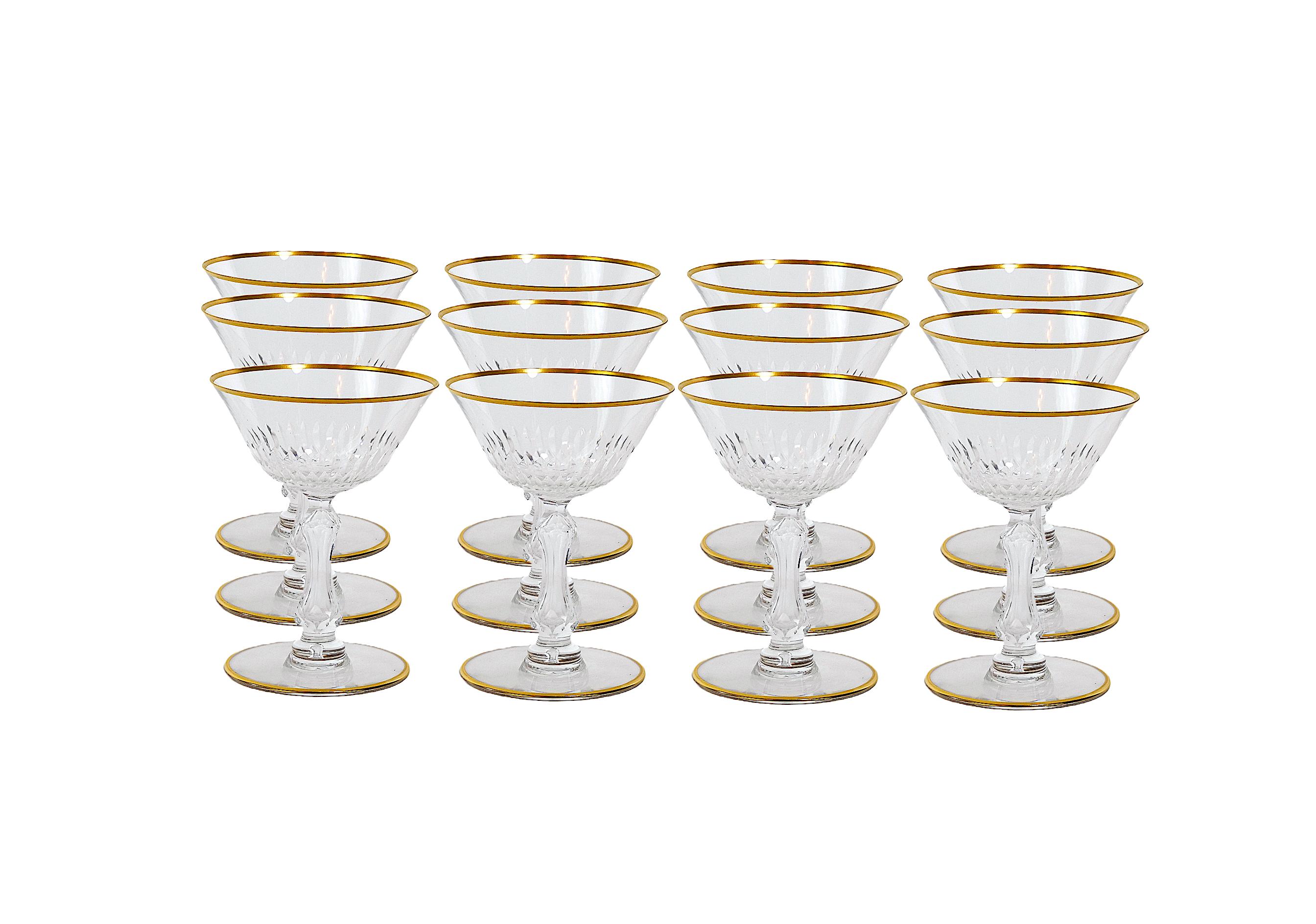 Richly hand cut and mouth blown with hand gilt gold trim top / base barware and tableware champagne coupe service for 12 people. Each glass features a deep cuts that allow the light to retract and shine to a brilliant finish from any angle. Mouth