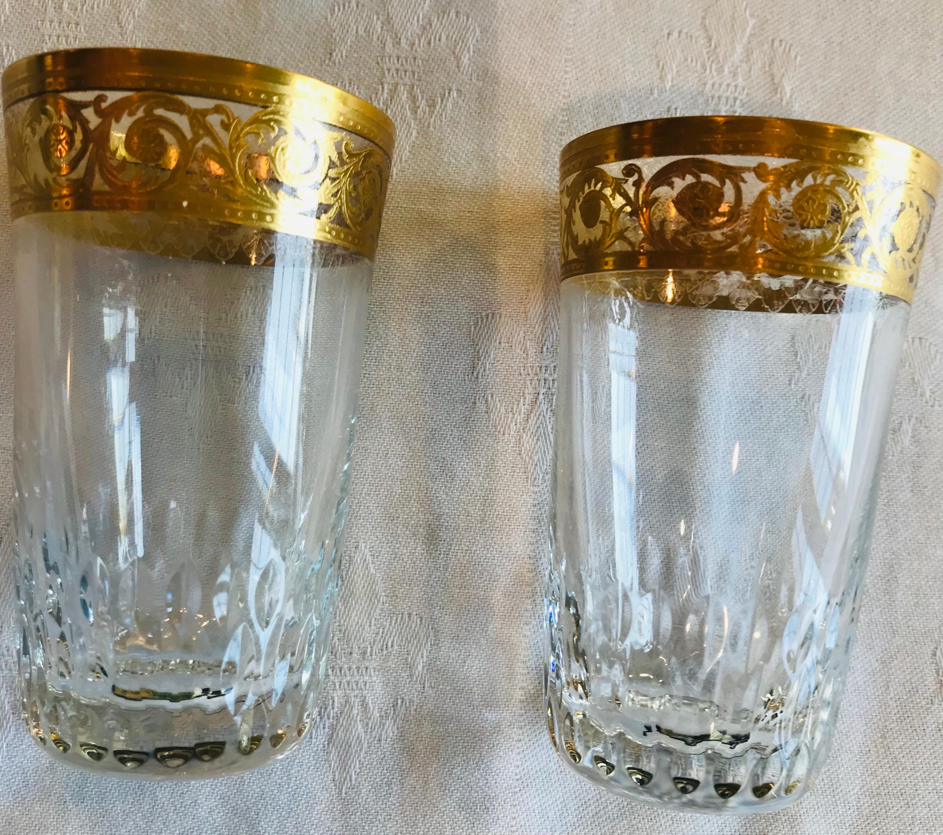 No longer in production, these delicately sized Saint Louis gold thistle cordial glasses clear glass with incising on the rim and faceting on the base. The glasses are not fluted in the body.

These mouth blown and incised glasses are heavily