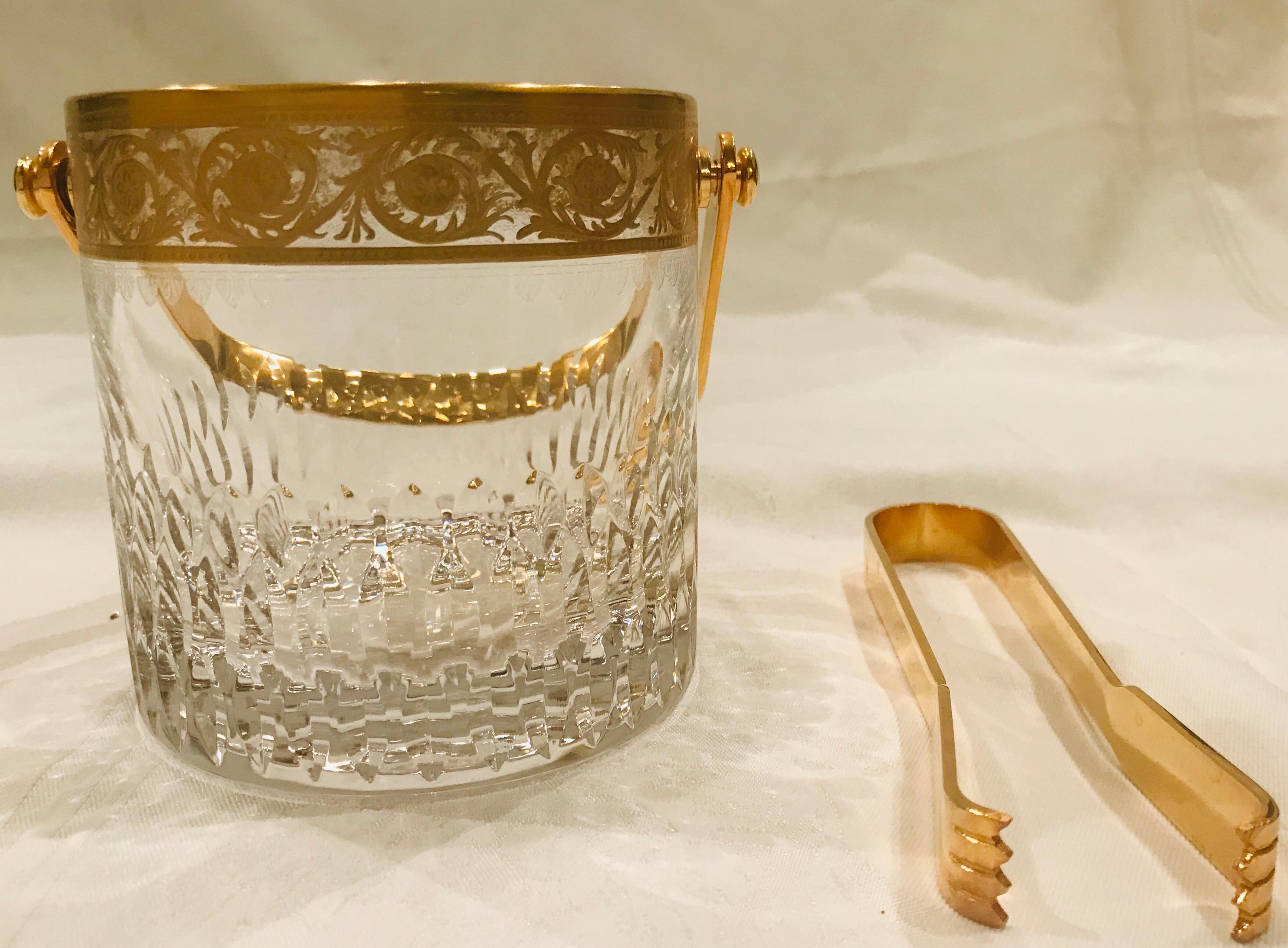 Saint Louis gold Thistle has been in continuous production since 1908 and has graced many formal tables in Europe and the world. This heavy, highly detailed ice bucket is from production in the late 1980s.

This item was used for display only in a
