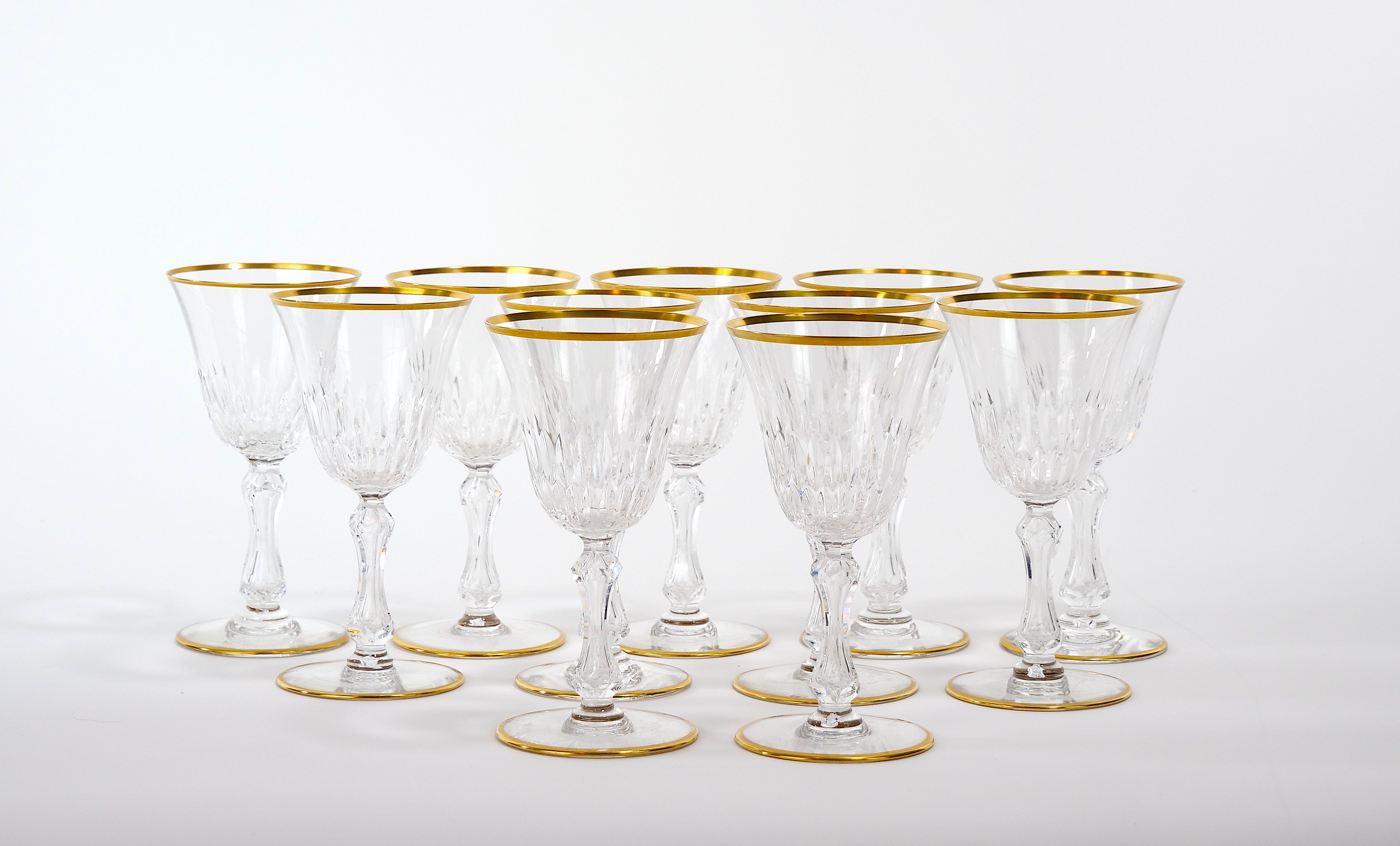Richly hand cut and mouth blown with hand gilt gold trim top / base barware and tableware glassware service for 10 people. Each glass features a deep cuts that allow the light to retract and shine to a brilliant finish from any angle. Mouth blown