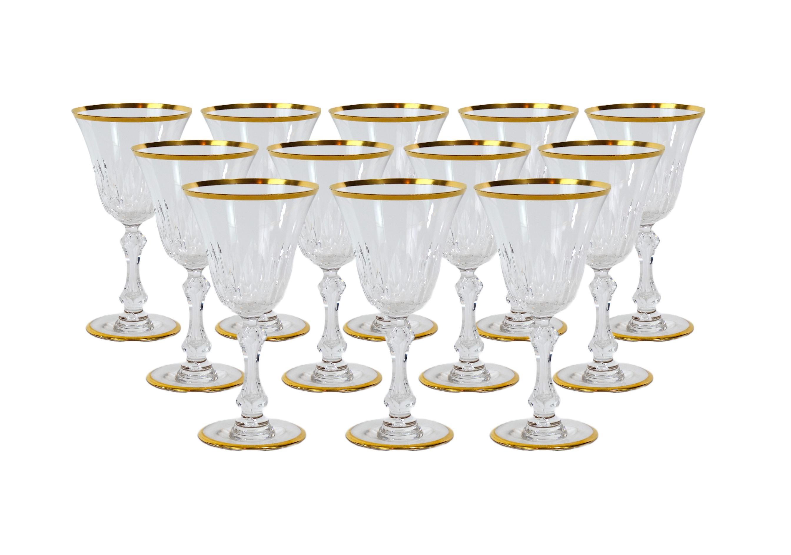 Richly hand cut and mouth blown with hand gilt gold trim top / base barware and tableware glassware service for 12 people. Each glass features a deep cuts that allow the light to retract and shine to a brilliant finish from any angle. Mouth blown