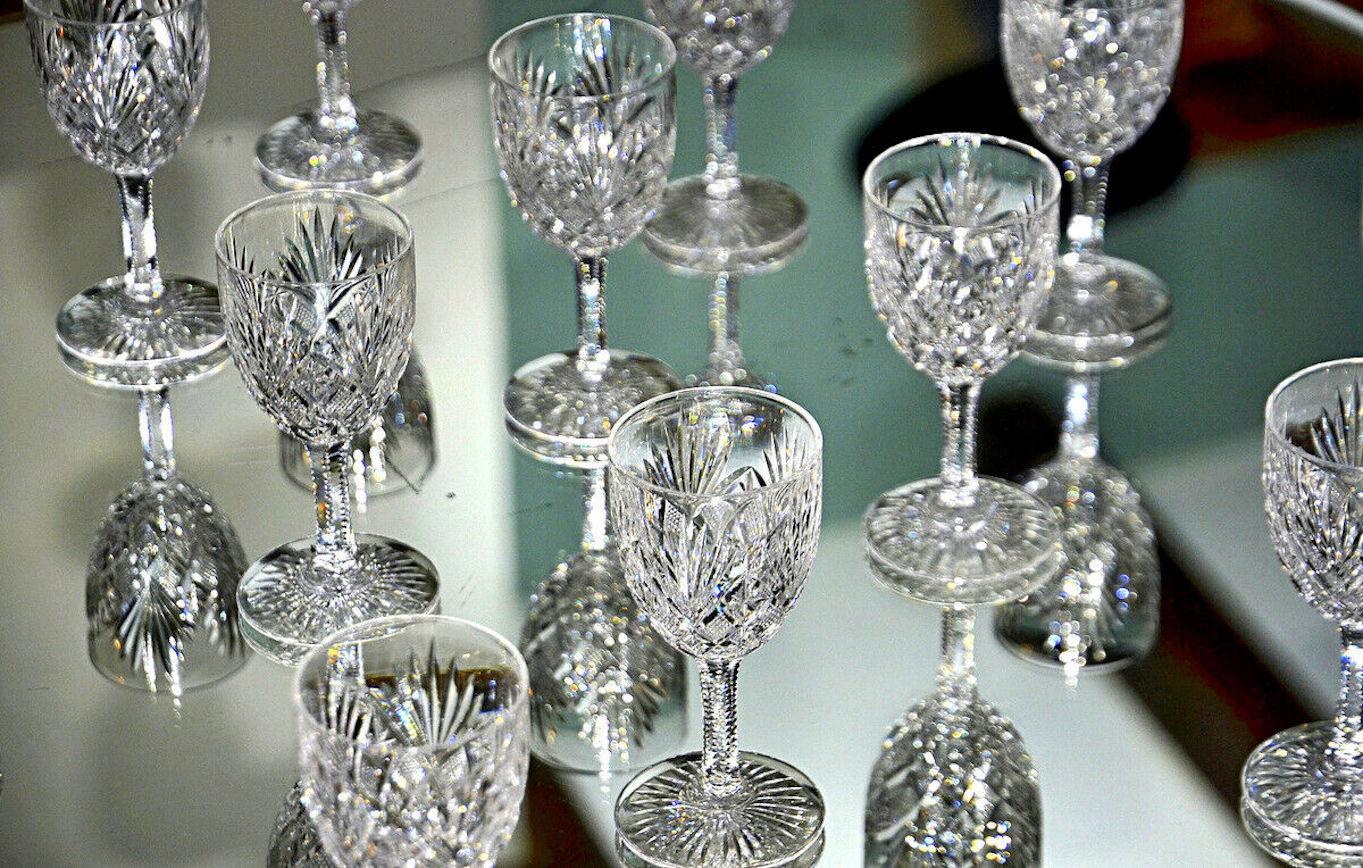 A truly elegant, rare and exceptional vintage 10-piece crystal wine glass service set by Saint Louis, France. 
We have 2 sets of 10.  

We offer these 10 wine glasses in translucent blown crystal on a hexagonal leg with richly carved decoration on