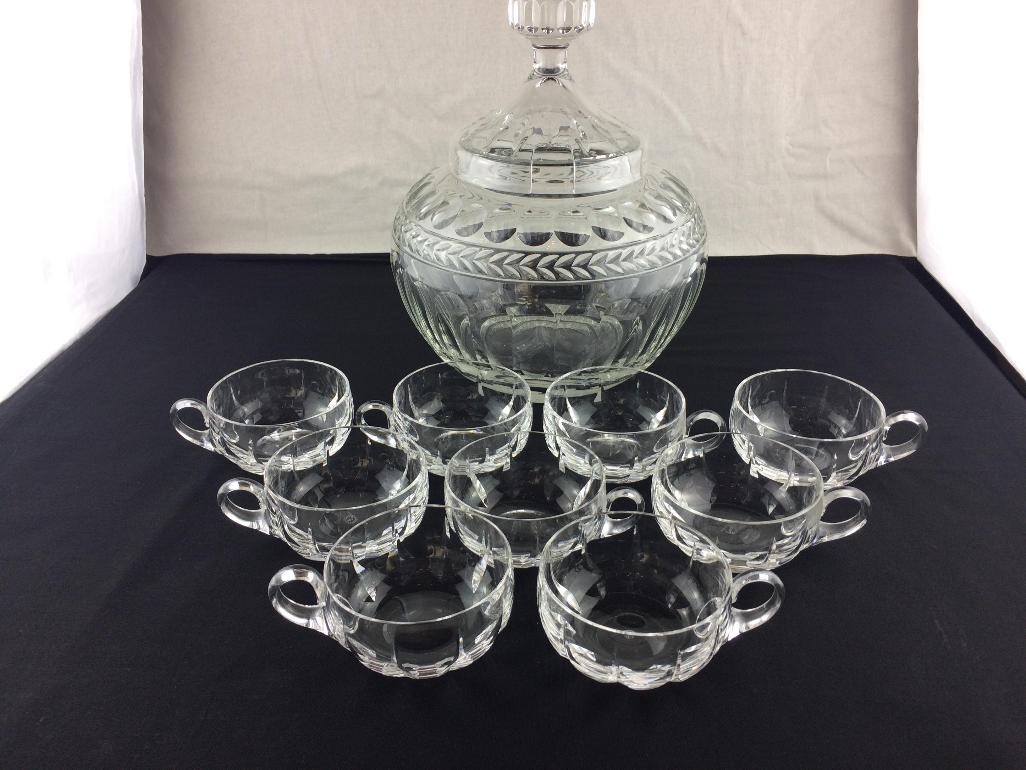 Elevate your home bar with this exquisite Saint Louis cut crystal liquor or punch service set. Crafted from high-quality crystal and glass by the renowned French manufacturer Saint Louis, this set features a captivating design with two offset rows