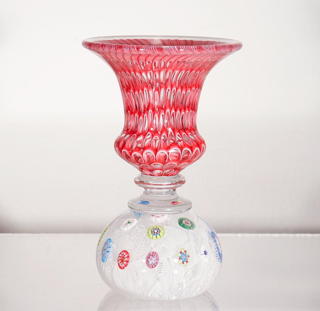 A rare French paperweight vase.

By the St. Louis Glass Company.

With a paperweight base with spaced millefiori canes on a white muslin ground supporting a honeycomb decorated vase with a white latticino rim.

The base contains a cane with a