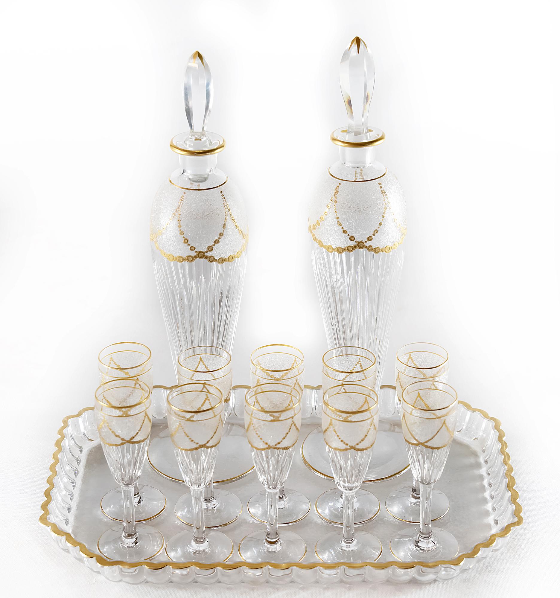 Antique French Saint Louis cut and frosted crystal liqueur set finely decorated with gilded ornaments, that includes:
Goblets  10 pcs.
Decanters 2 pcs.
Decanter stoppers 2 pcs.
Tray 1 pcs.
Measurements are of complete set in primary photo.
Model