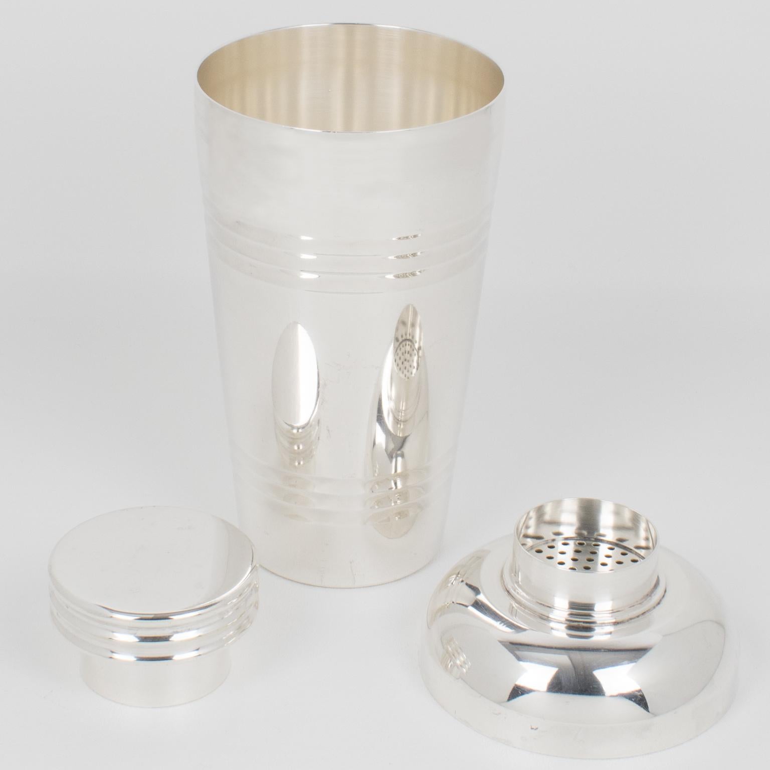This sophisticated three-sectioned cocktail shaker was crafted by the renowned silversmith Saint Medard in Paris in the 1940s. The beautiful Art Deco design features a geometric pattern and is adorned with a removable cap and strainer. The underside