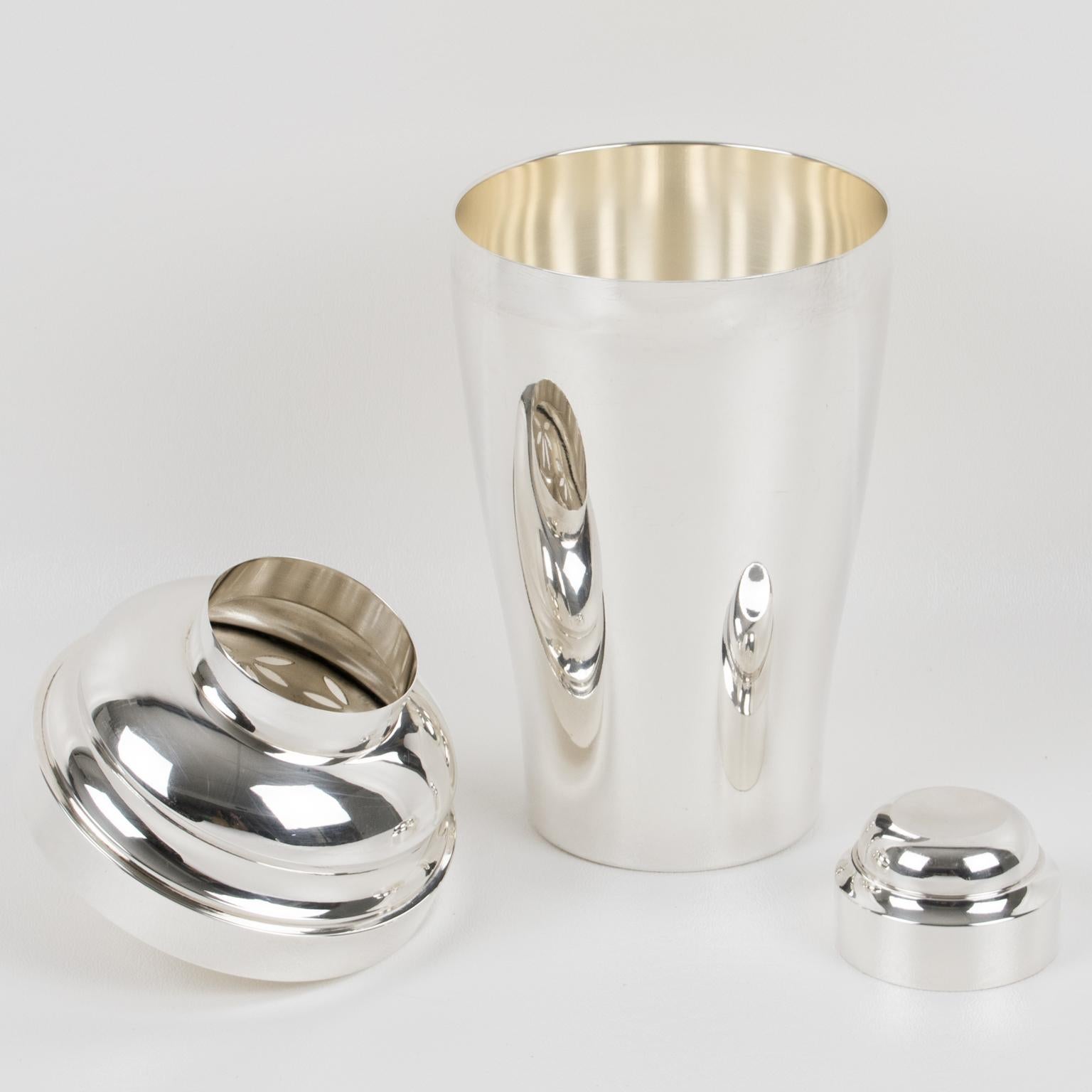This superb three-section cocktail shaker was crafted by the renowned silversmith Saint Medard in Paris. The beautiful Art Deco flair features a geometric pattern. The shaker is adorned with a removable cap and a built-in lemon squeezer inside the