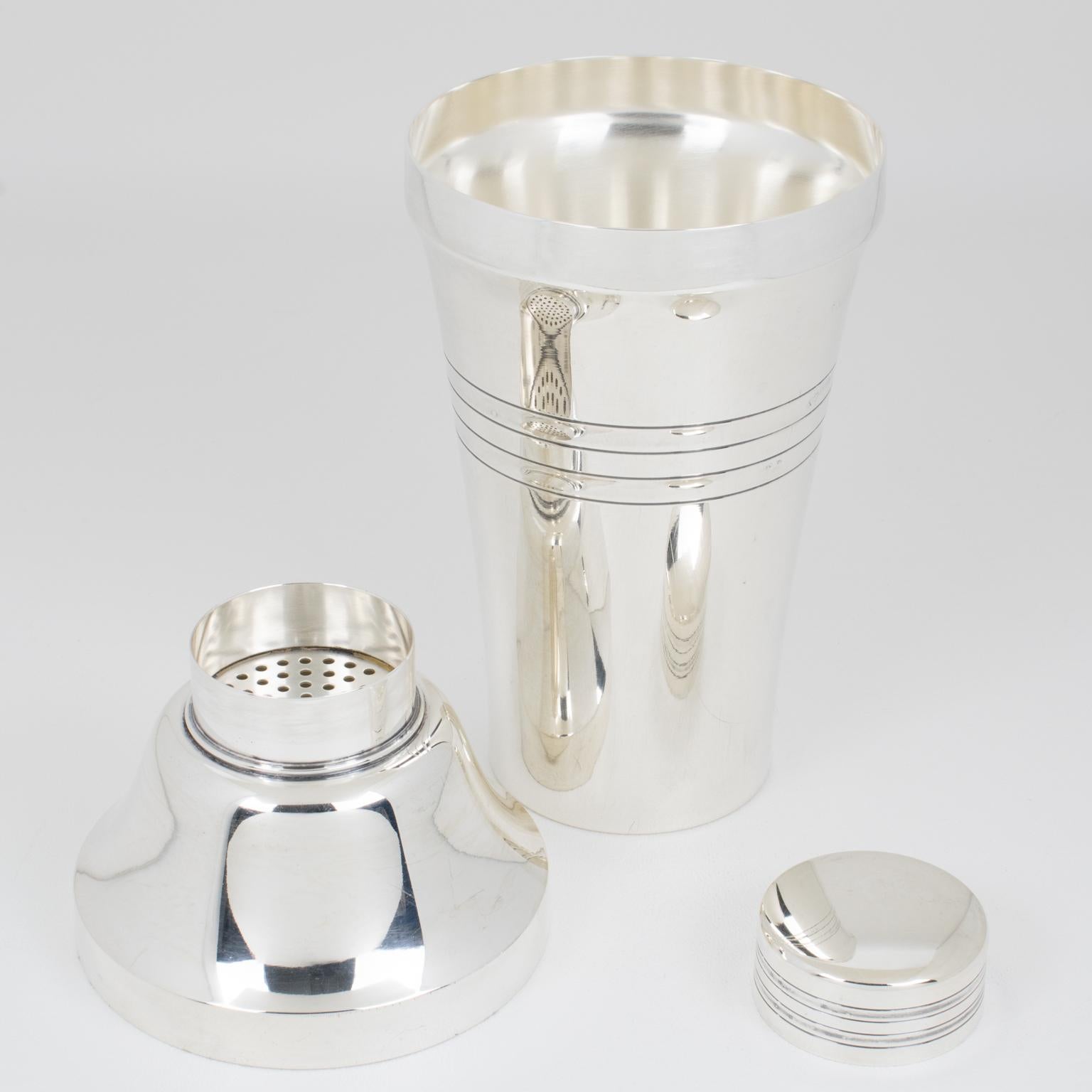 This refined three-sectioned cocktail shaker was crafted by the renowned silversmith Saint Medard in Paris for the Le Chardon Collection. The beautiful Art Deco design features a geometric pattern and is adorned with a removable cap and filter