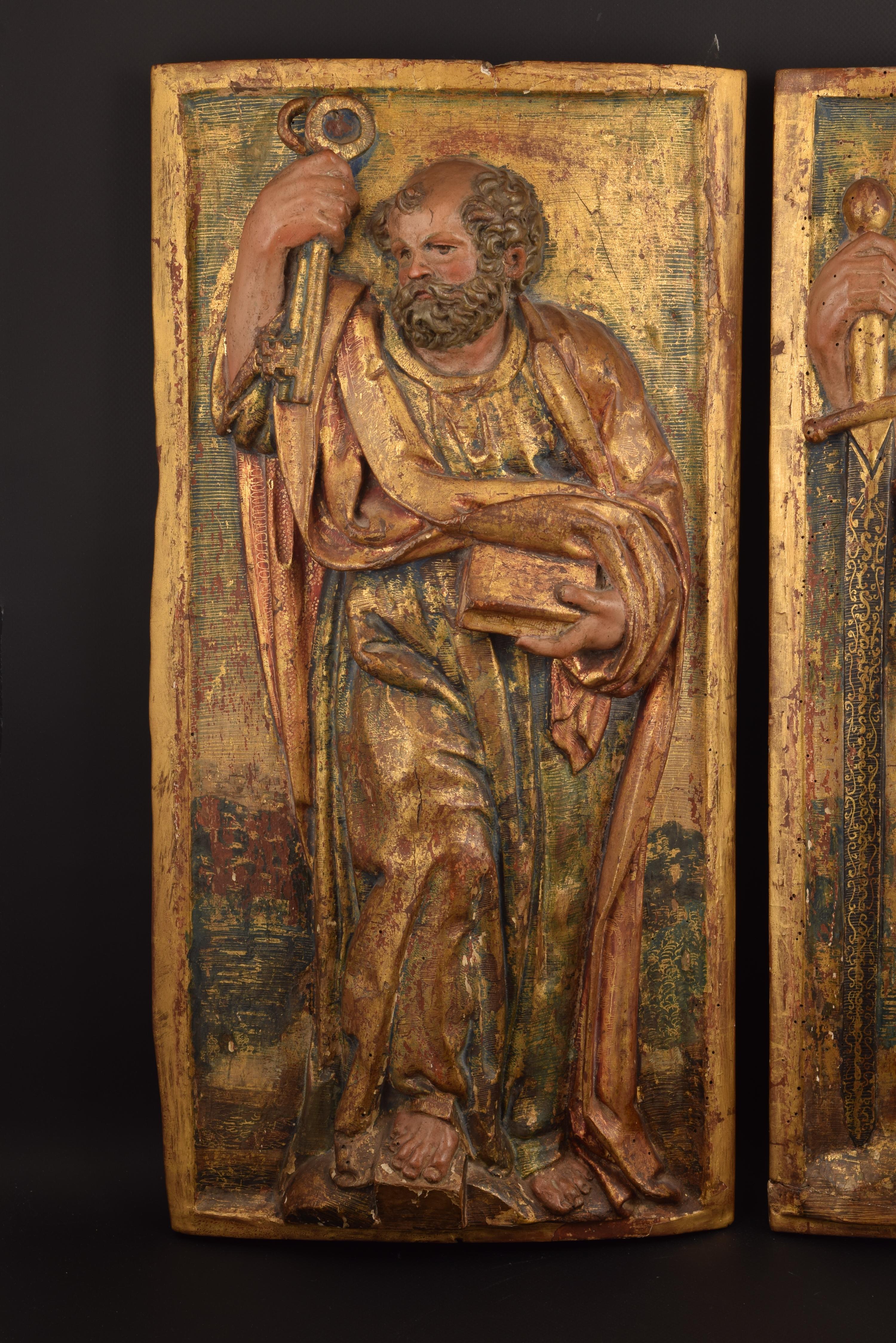 The present reliefs would be part of an altarpiece surely, given its rectangular shape and the fact of being worked only in the front. Note also the great quality of the carving and the polychrome and gold, well preserved. On the back they have two