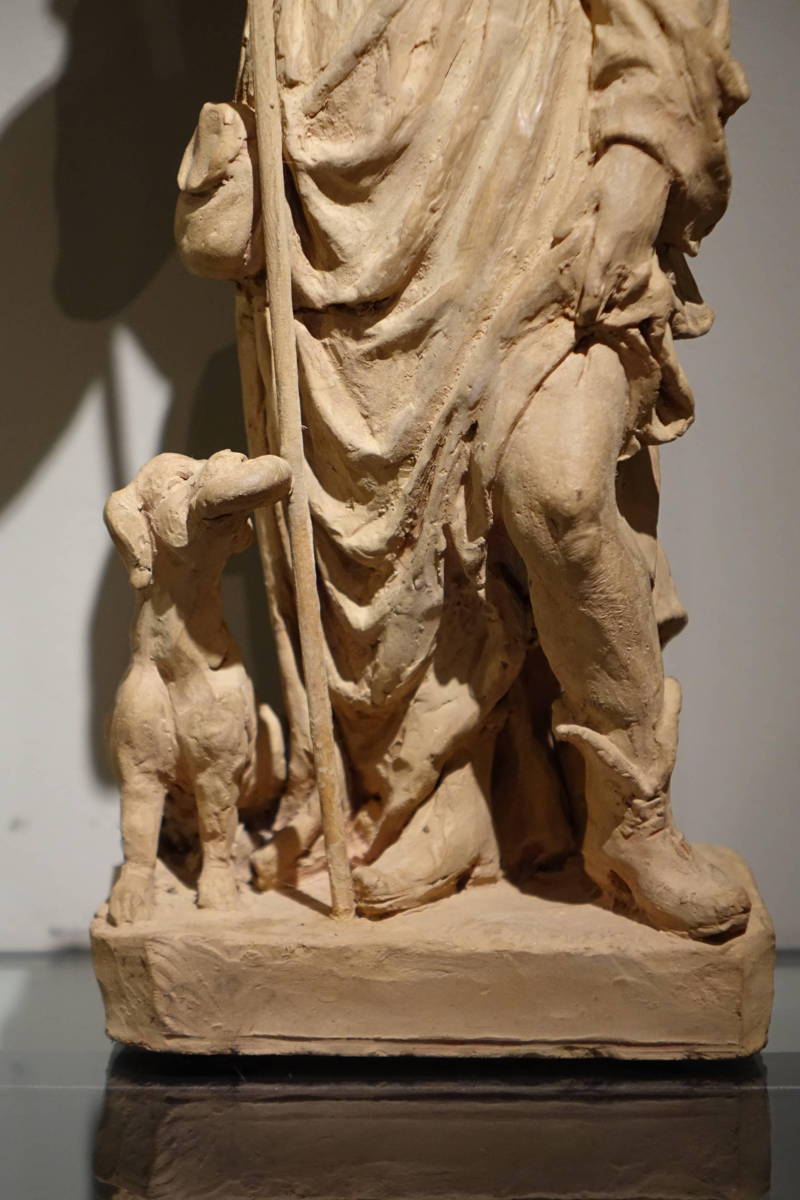 Saint Rocco, unique, original terracotta statue, France, 18th century
On his return from Rome in 1371, Saint Roch or Rocco suffered from the plague.
In order not to risk spreading the contagion, he retired in the woods, where he was fed by the dog