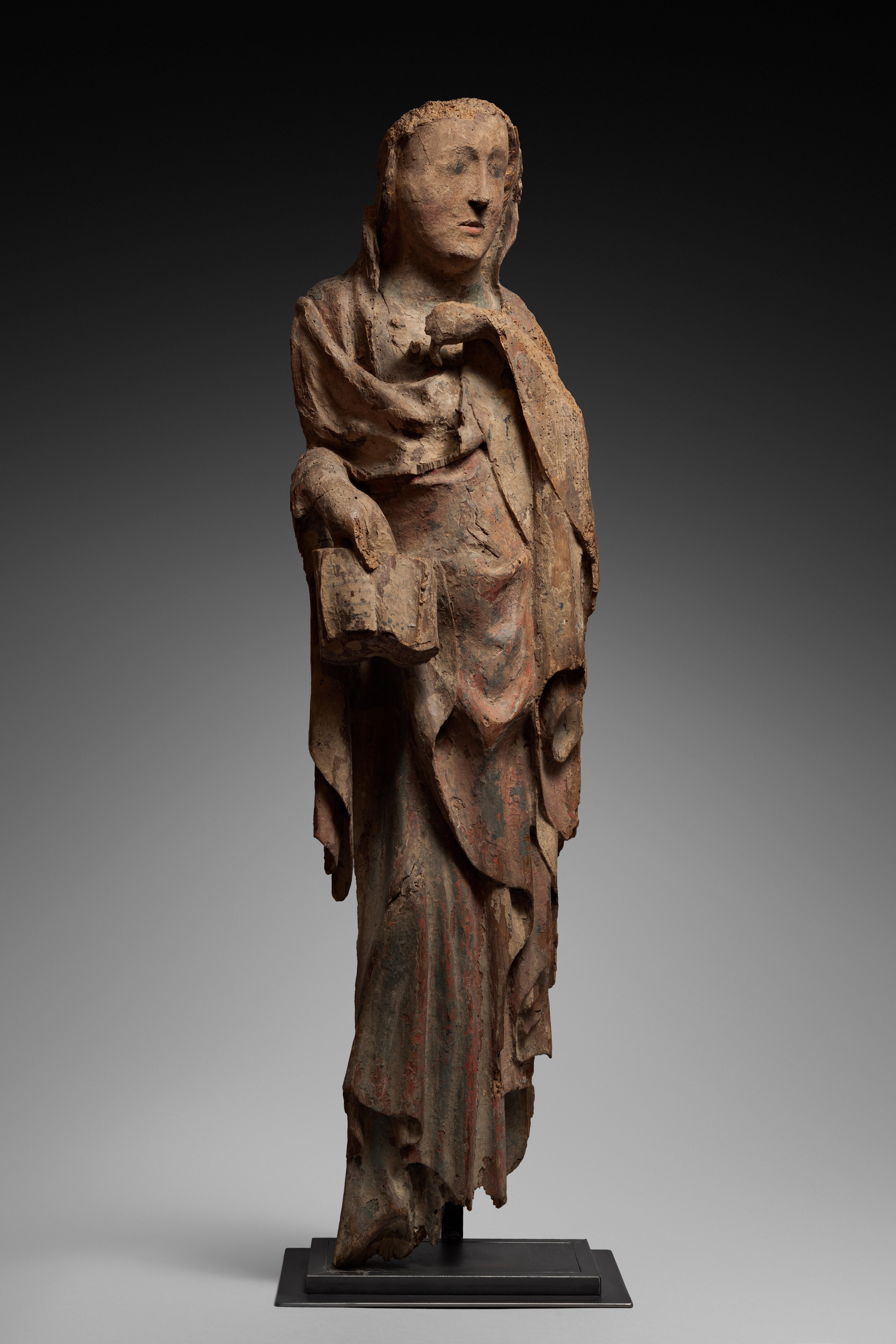 SAINT WOMAN IN POLYCHROME CARVED WOOD
 
ORIGIN : ITALY
PERIOD : late 13th century
 
Height : 103 cm
Length : 28  cm
Width : 16 cm
 Remains of polychromy
 
This holy woman is depicted in a perfectly frontal position.
Her attitude is still marked by