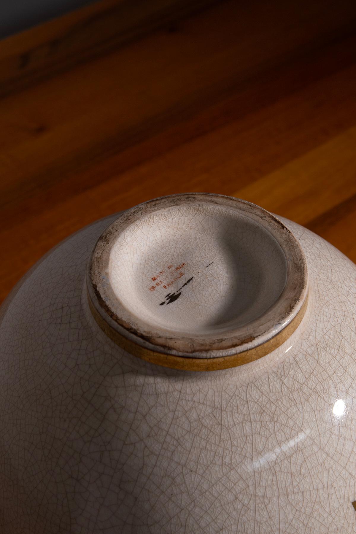 Discover the elegance and charm of the French Art Deco period with this stunning vase from Sainte Radegonde. Crafted in France around 1925, this exquisite piece is a testament to the era's rich artistic expression. The vase features a white ceramic