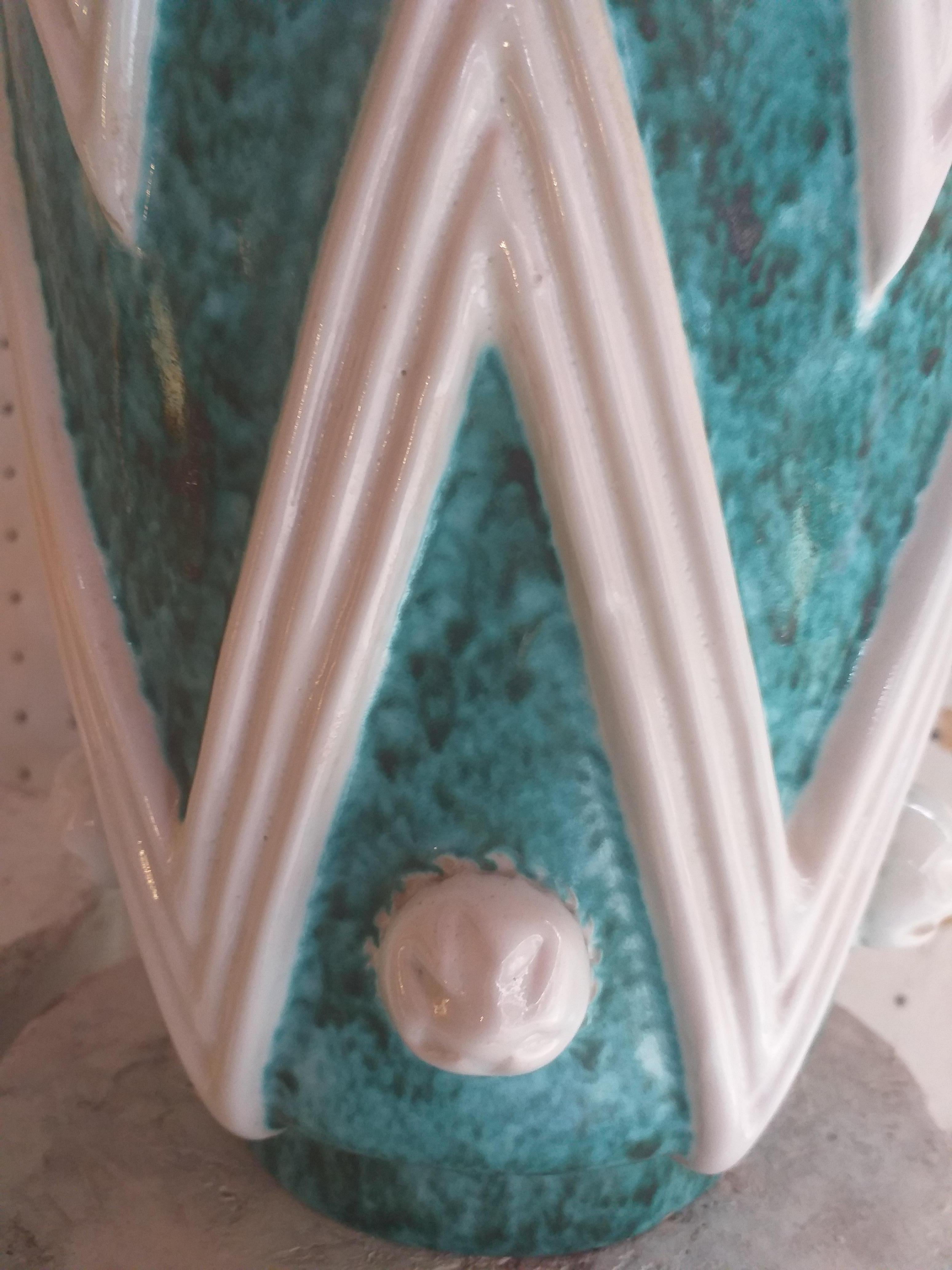 A turquoise glazed ceramic vase with white ornamental motifs made by the Sainte-Radegonde workshop and the Ateliers Primavera.