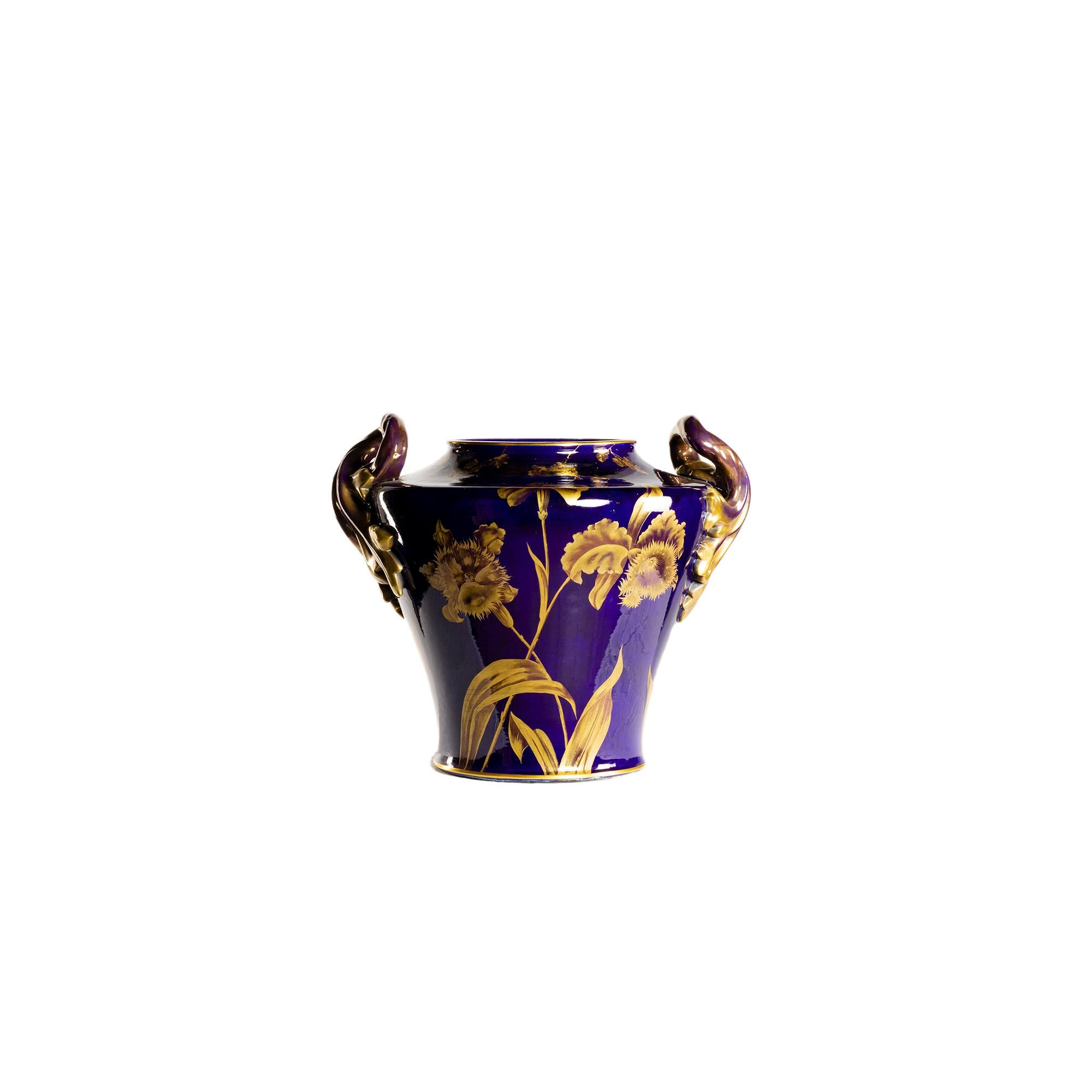 A beautiful two-handled large ceramic vase depicting Virginia creeper in flower made of gilding on a blue of Tours background.
A model by Gustave Asch, renowned ceramic sculptor who worked in Sainte Radegonde (Rodez, Aveyron).  
Ax (Sainte-Radegonde