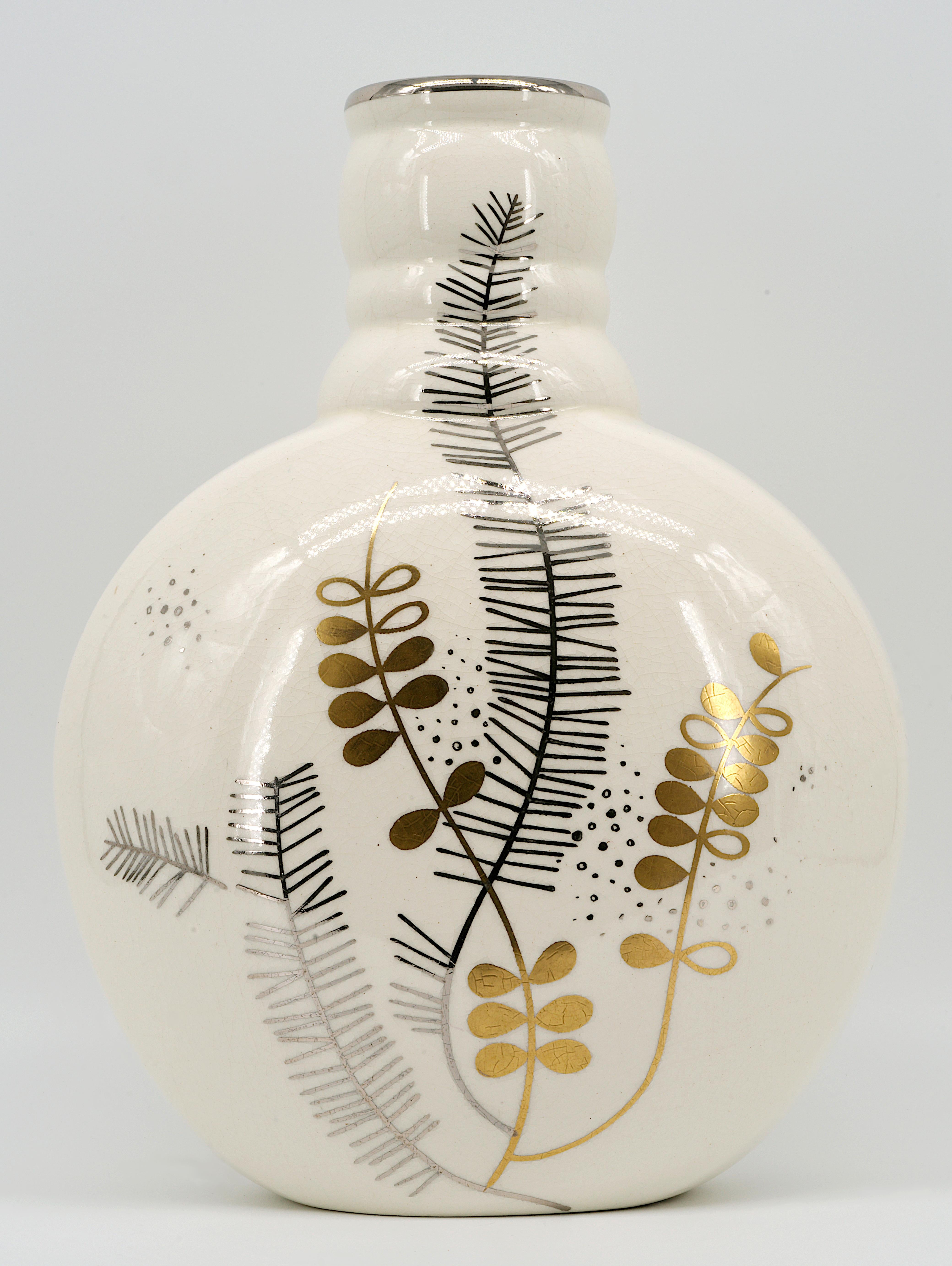 This elegant ceramic vase, created by Sainte-Radegonde in France during the 1920s, embodies the refined aesthetic of the Art Deco period. The vase features stylized platinum and gilt floral decorations set against a crackle glaze ceramic, adding a