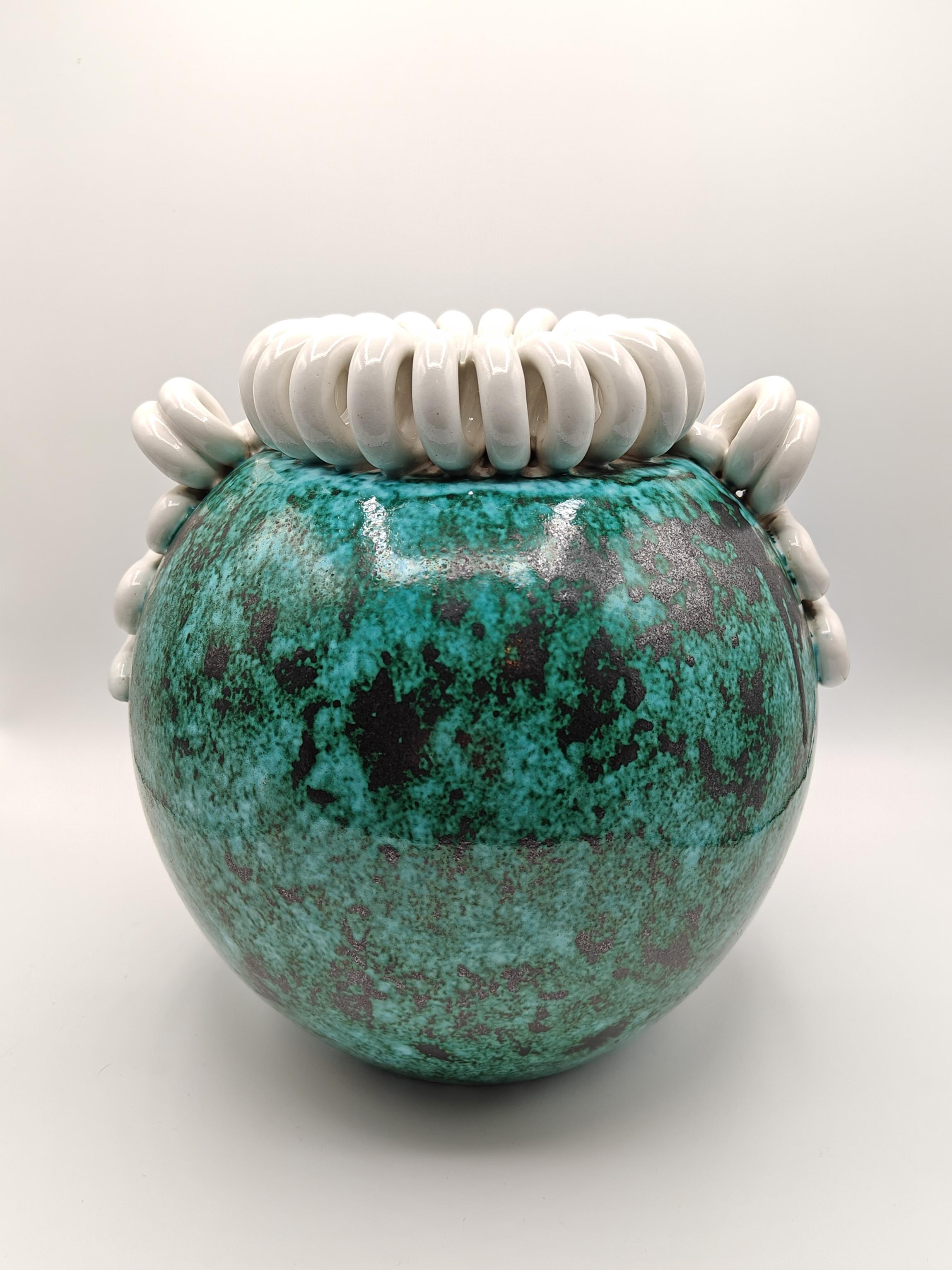 Magnificent enamelled ceramic vase from the 1930s. With a pot-bellied volume, this vase is enamelled with shades of green, from light to dark. 
The top of the vase has this neck in twisted coils, well known from the pottery of Sainte-Radegonde. 
On