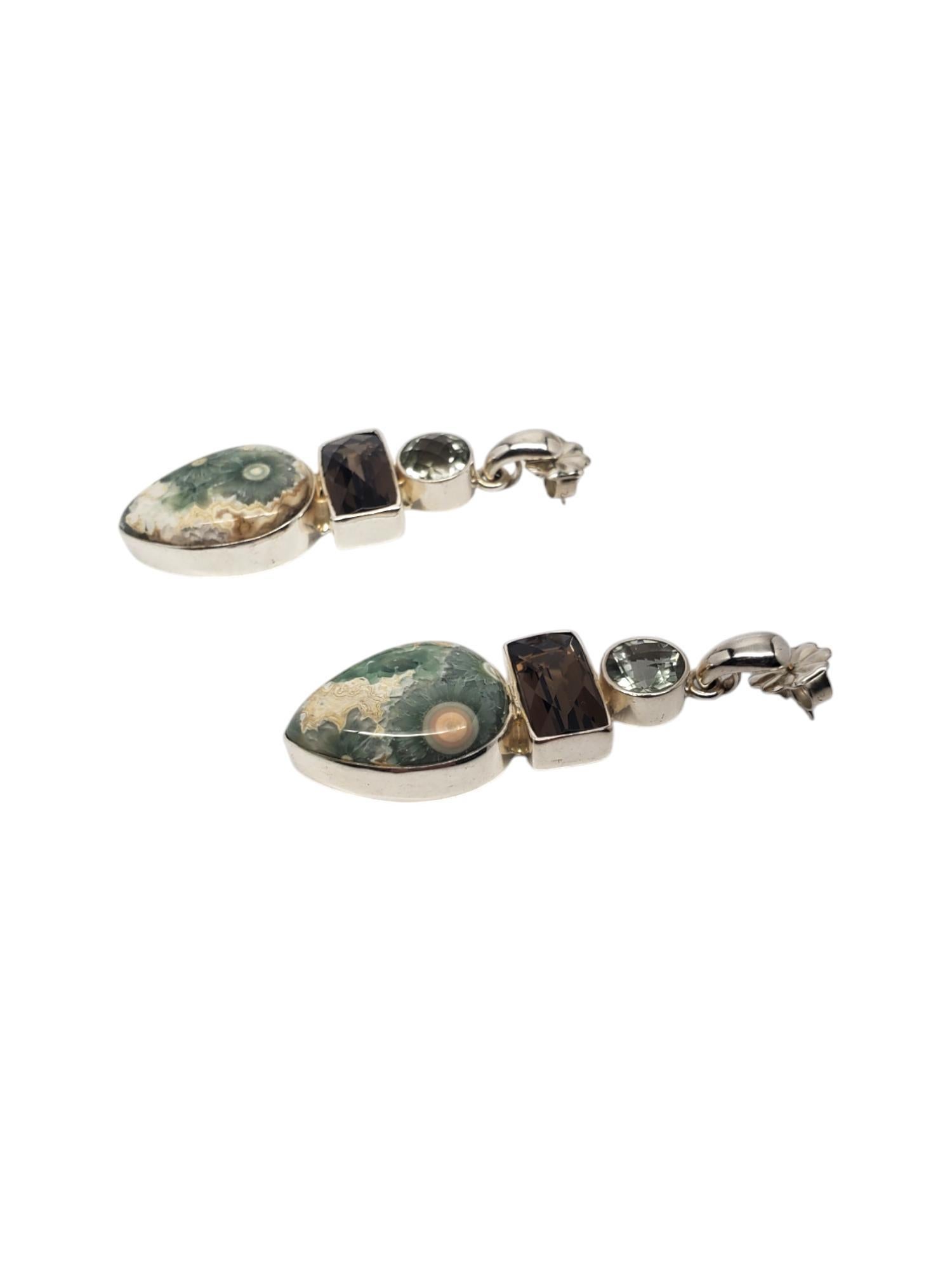 Boucles d'oreilles Sajen en argent sterling avec plusieurs pierres en forme de poire 

Ces magnifiques boucles d'oreilles percées de Sajen sont ornées de pierres précieuses rondes, rectangulaires et en forme de poire, serties dans de l'argent