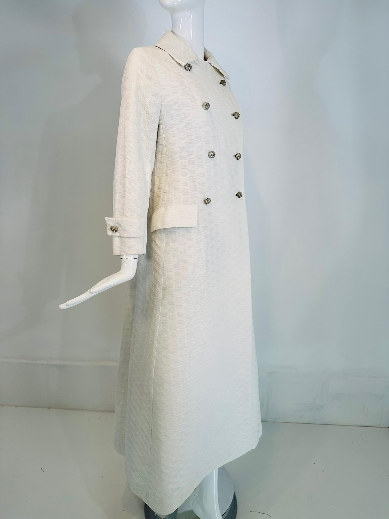 Saks Fifth Avenue 1970s white cotton jacquard double breasted rhinestone button evening coat. Double breasted coat closes with silver metal dome top rhinestone buttons & bound button holes. There are fabric covered snaps at the neck top, the coat