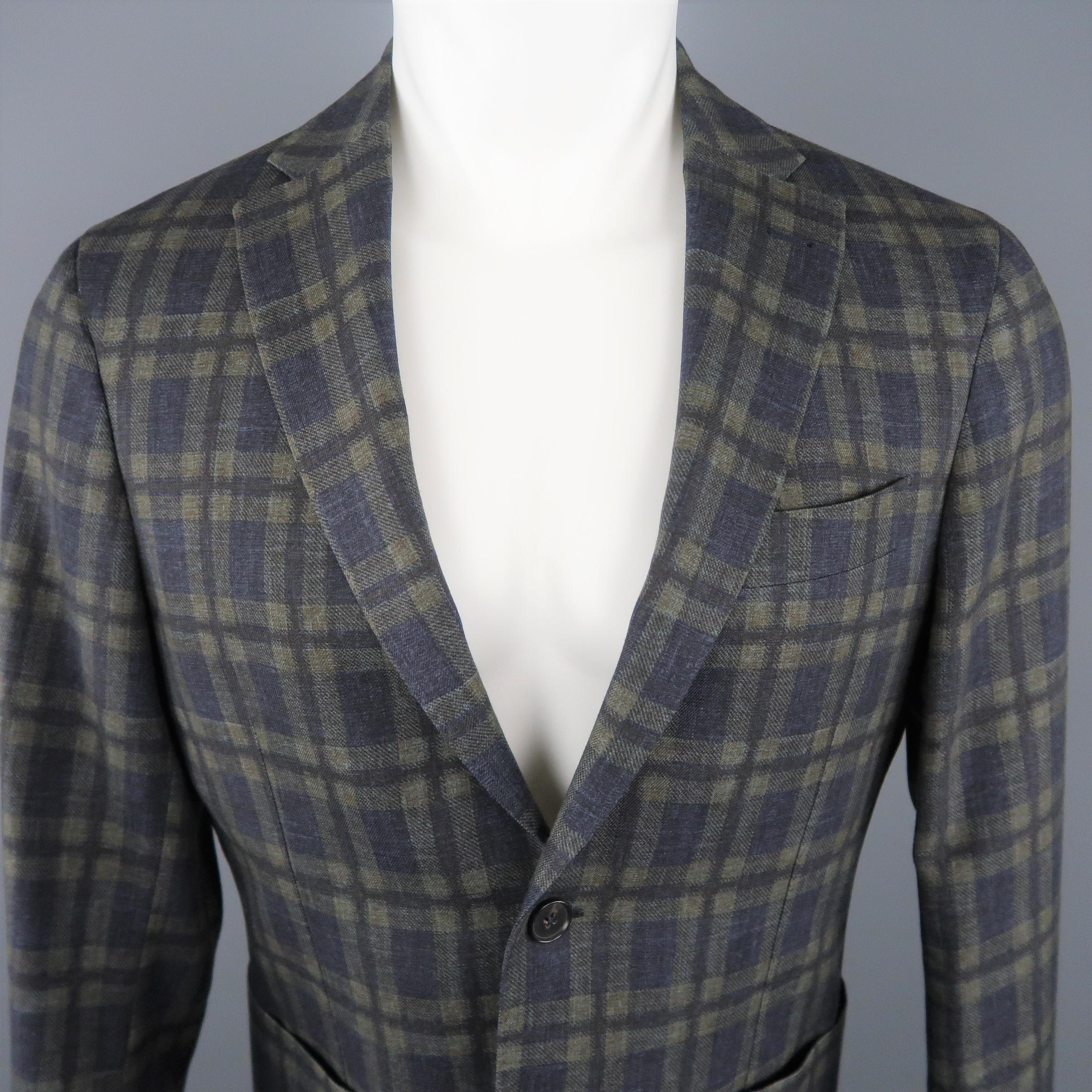 SAKS FIFTH AVENUE Sport Coat comes in a charcoal tone in a plaid wool material, with a notch lapel, slit and patch pockets, 2 buttons at closure, single breasted, functional buttons at cuffs and double vent at back. Made in Italy.
 
Excellent