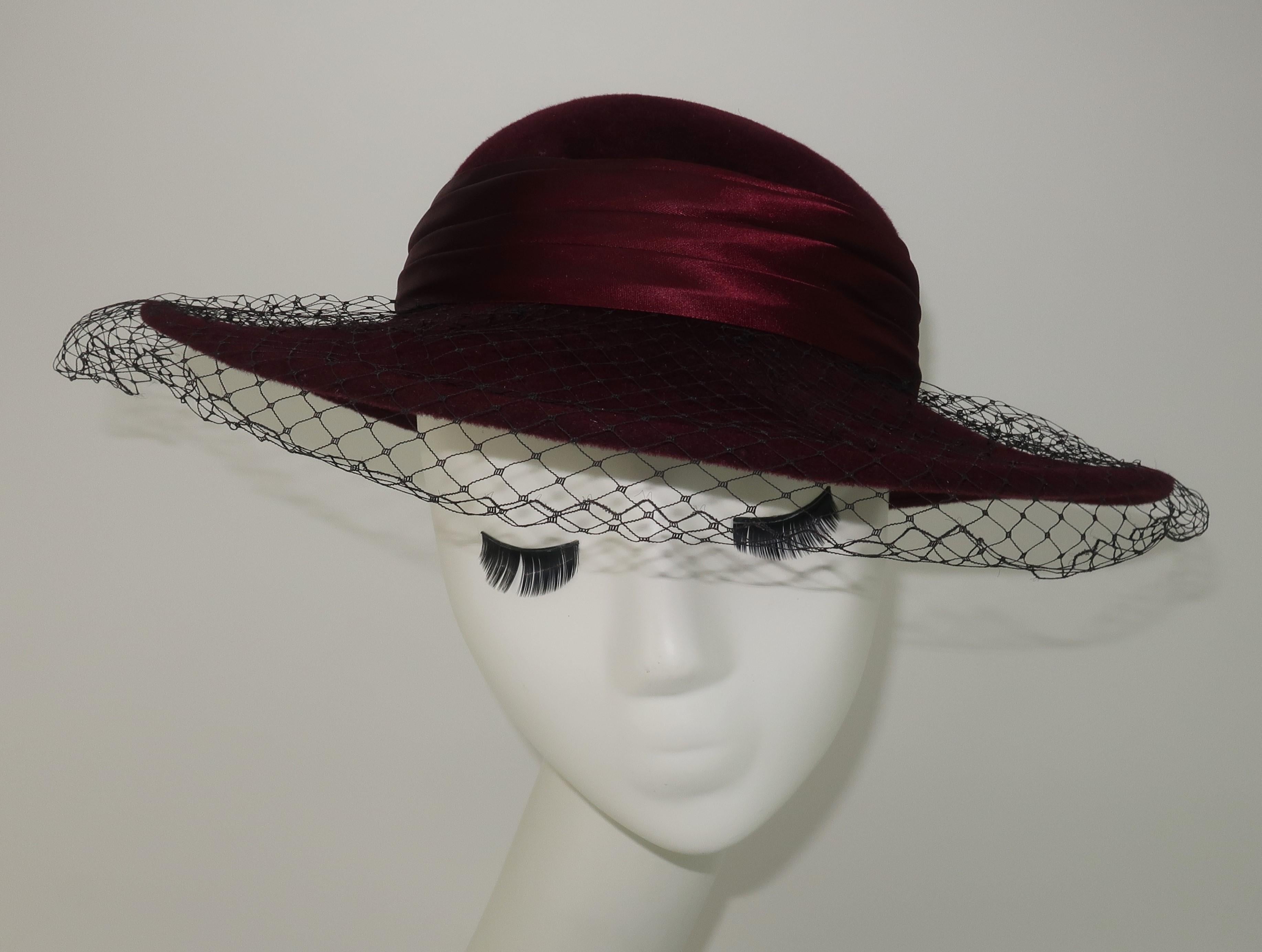 1980's Saks Fifth Avenue aubergine wool felt hat with a wide brim, coordinating satin band and demure black net.  A perfect touch of class!
CONDITION
Good vintage condition with some wear and signs of storage.  There is a subtle small spot to the