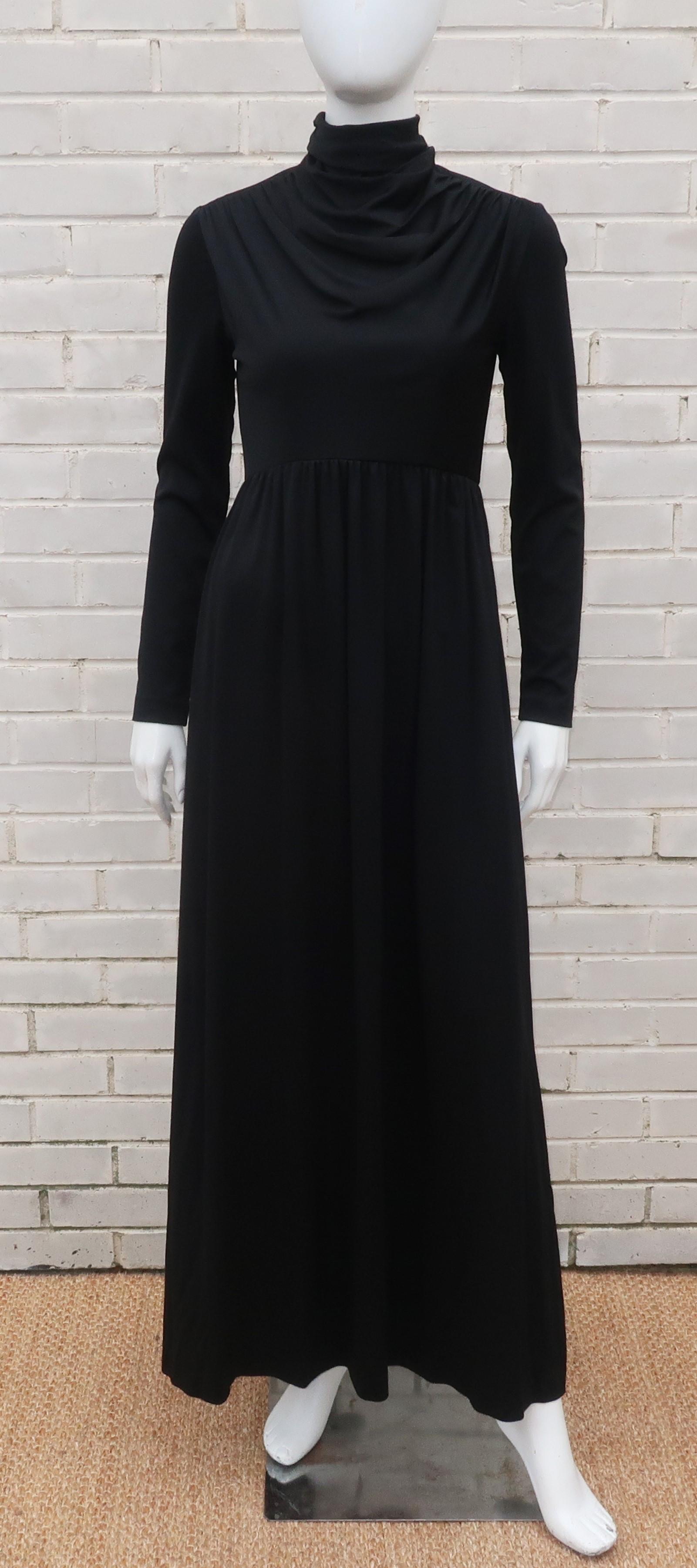C.1970 Saks Fifth Avenue black jersey maxi dress with a fitted bodice, long sleeves and a draping cowl neck.  The dress zips at the back with a slinky fitted silhouette.  Perfect for a casual evening out or at home hostess wear.
CONDITION
Very good
