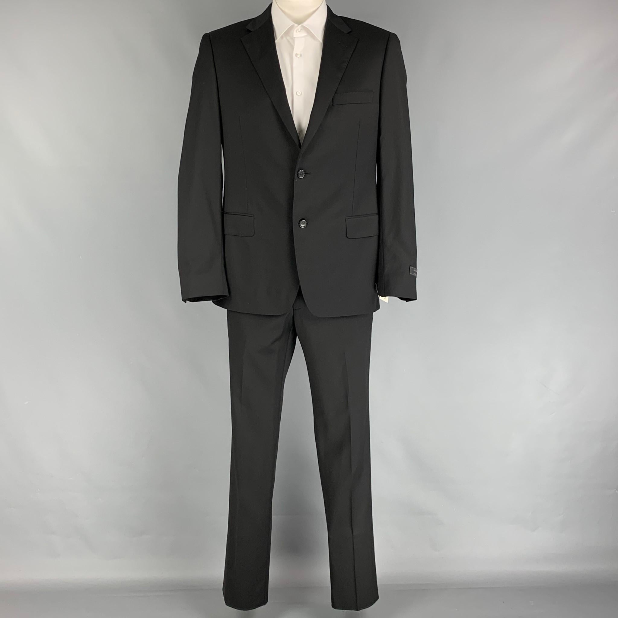 SAKS FIFTH AVENUE by SAMUELSOHN suit comes in black wool with a full liner and includes a single breasted, double button sport coat with a notch lapel and matching flat front trousers.

New With Tags.
Marked: 42-36