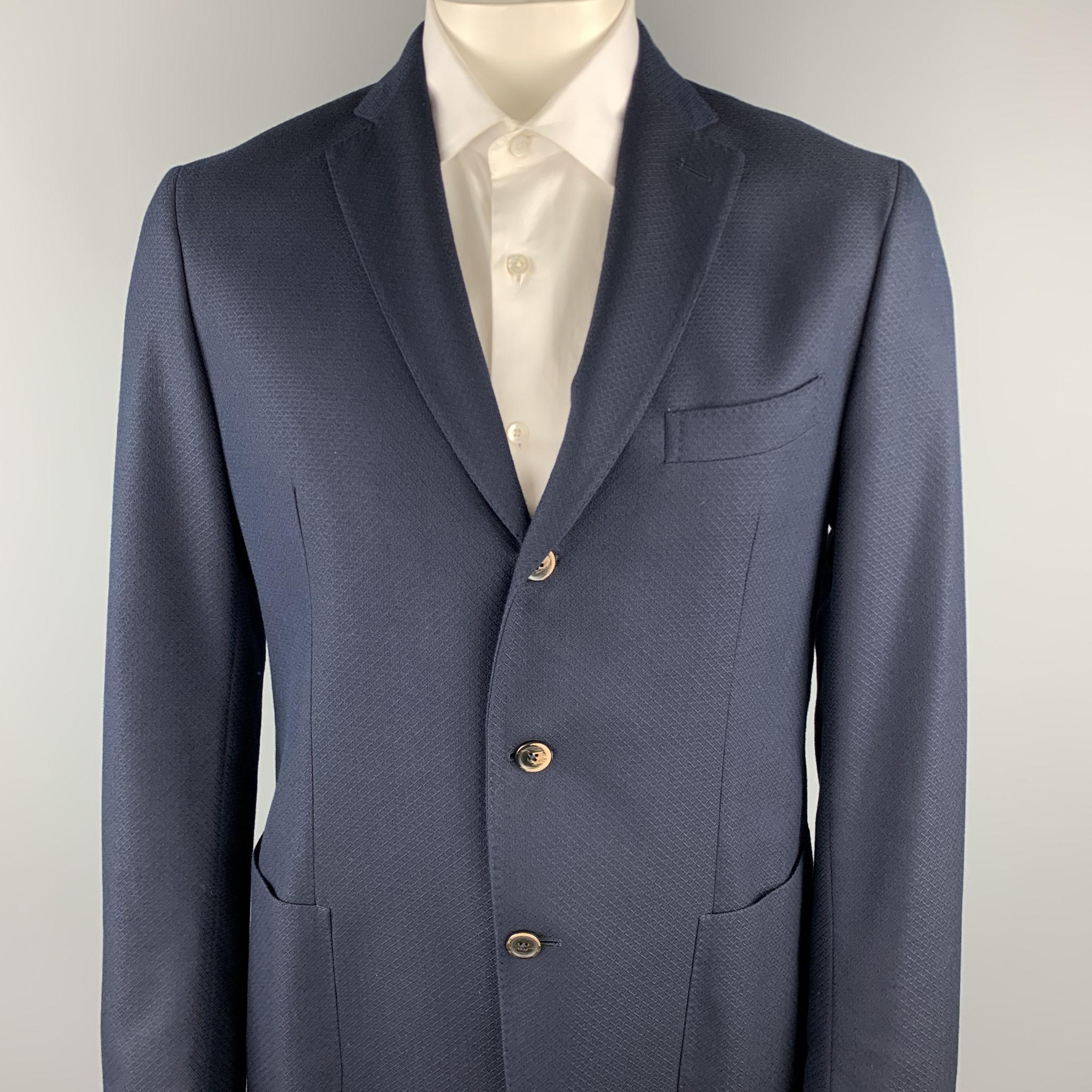 SAKS FIFTH AVENUE sport coat comes in a navy textured cotton / wool with a half liner featuring a notch lapel, patch pockets, and a three button closure. Made in Italy.

Excellent Pre-Owned Condition.
Marked: 44 R

Measurements:

Shoulder: 18 in.