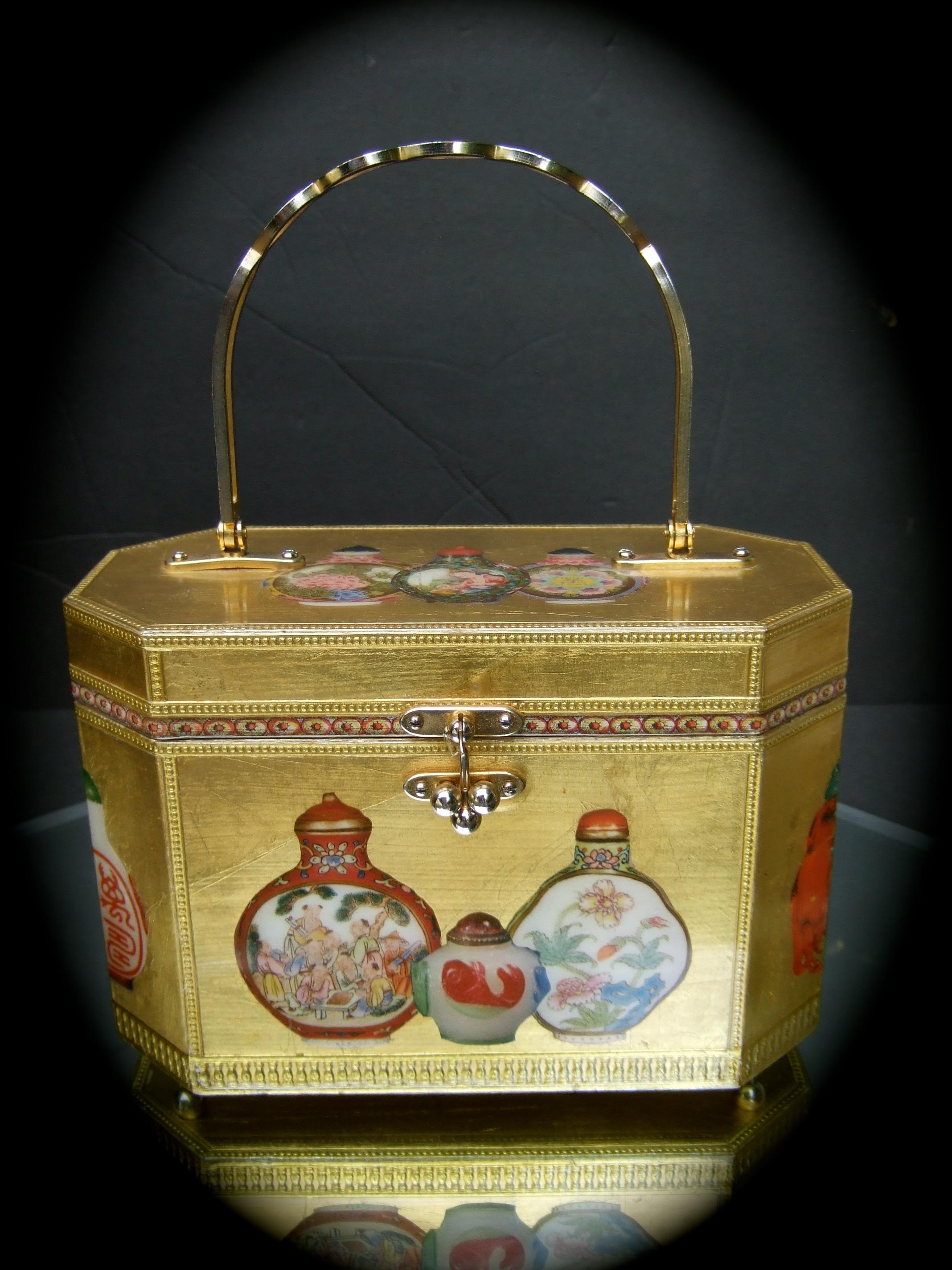 Saks Fifth Avenue Chinoiserie gilt wood decoupage box purse c 1970s
The elegant octagon shaped wood box purse is covered with luminous
gold enamel lacquer 

Decorated with decoupage Asian snuff bottles on the exterior 
Carried with a gilt metal