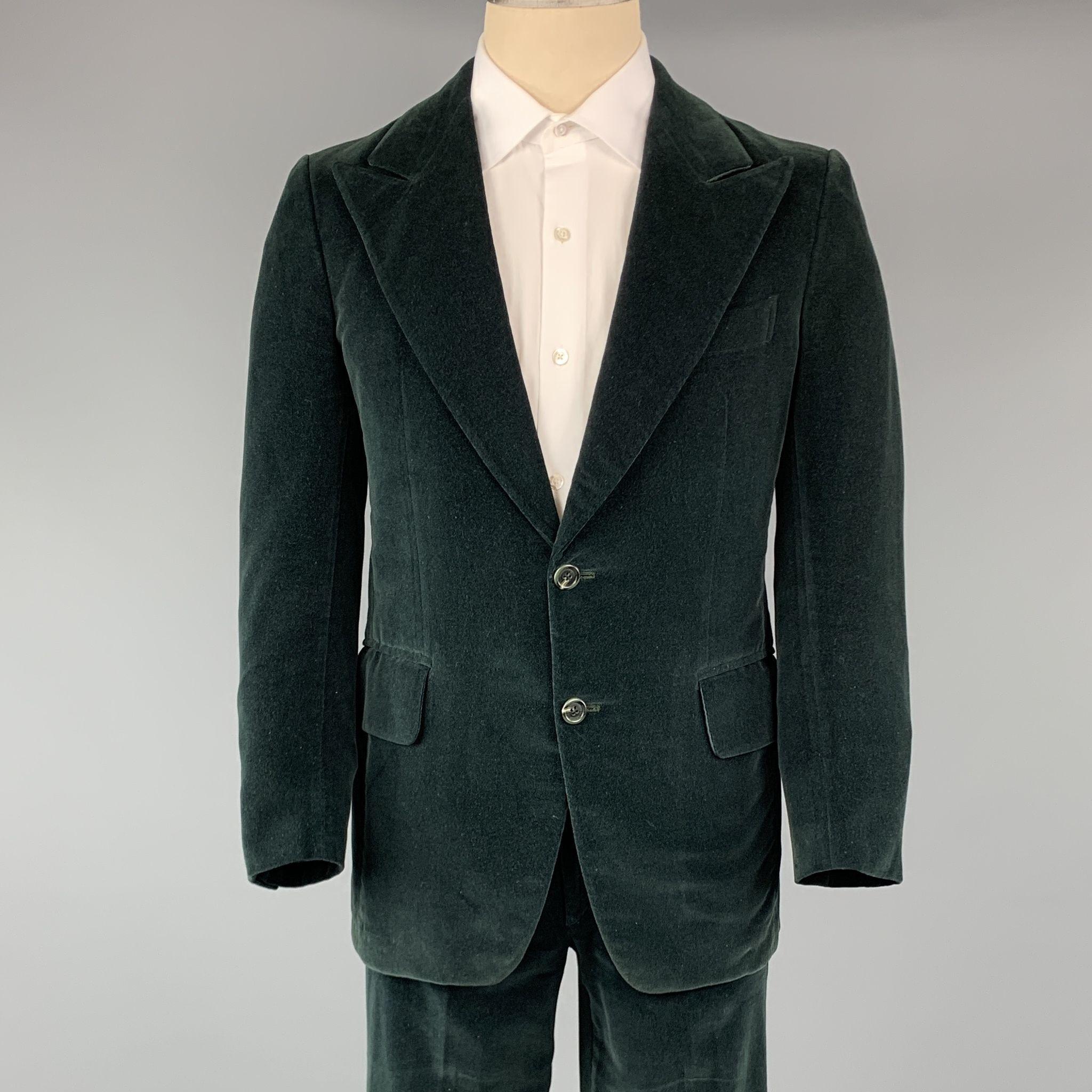 VINTAGE SAKS FIFTH AVENUE suit comes in a forest green velvet and includes a  single breasted, two button sport coat with a notch lapel and matching front trousers. (As-Is)

Good Pre-Owned Condition.
Marked: 38

Measurements:

-Jacket
l Shoulder: