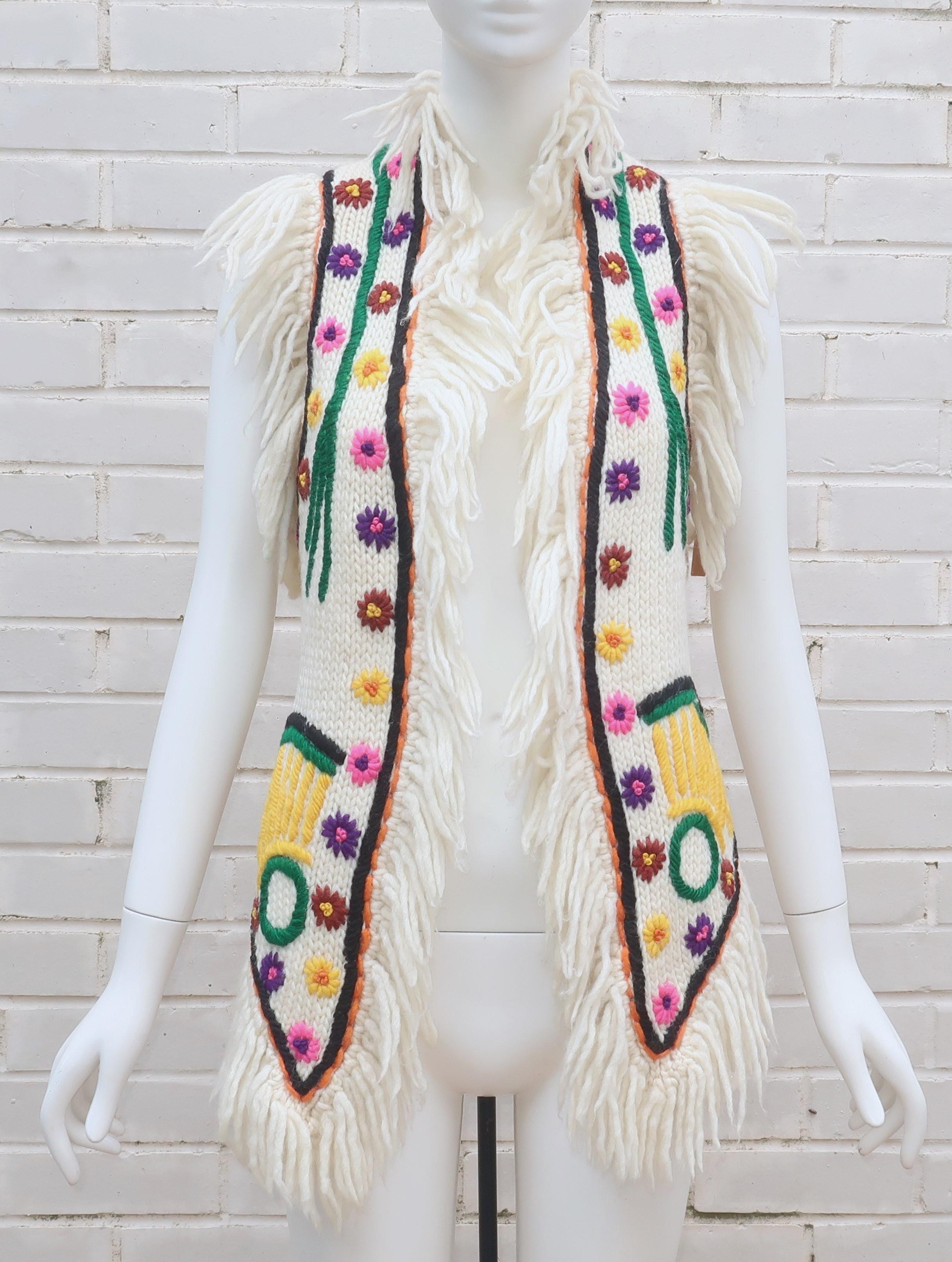 1960's boho chic at its best from the department store of high fashion, Saks Fifth Avenue!  A fun hippie style hand made wool sweater vest in a chunky yarn with colorful embroidery and fringe that is reminiscent of real fur.  The long vest has an