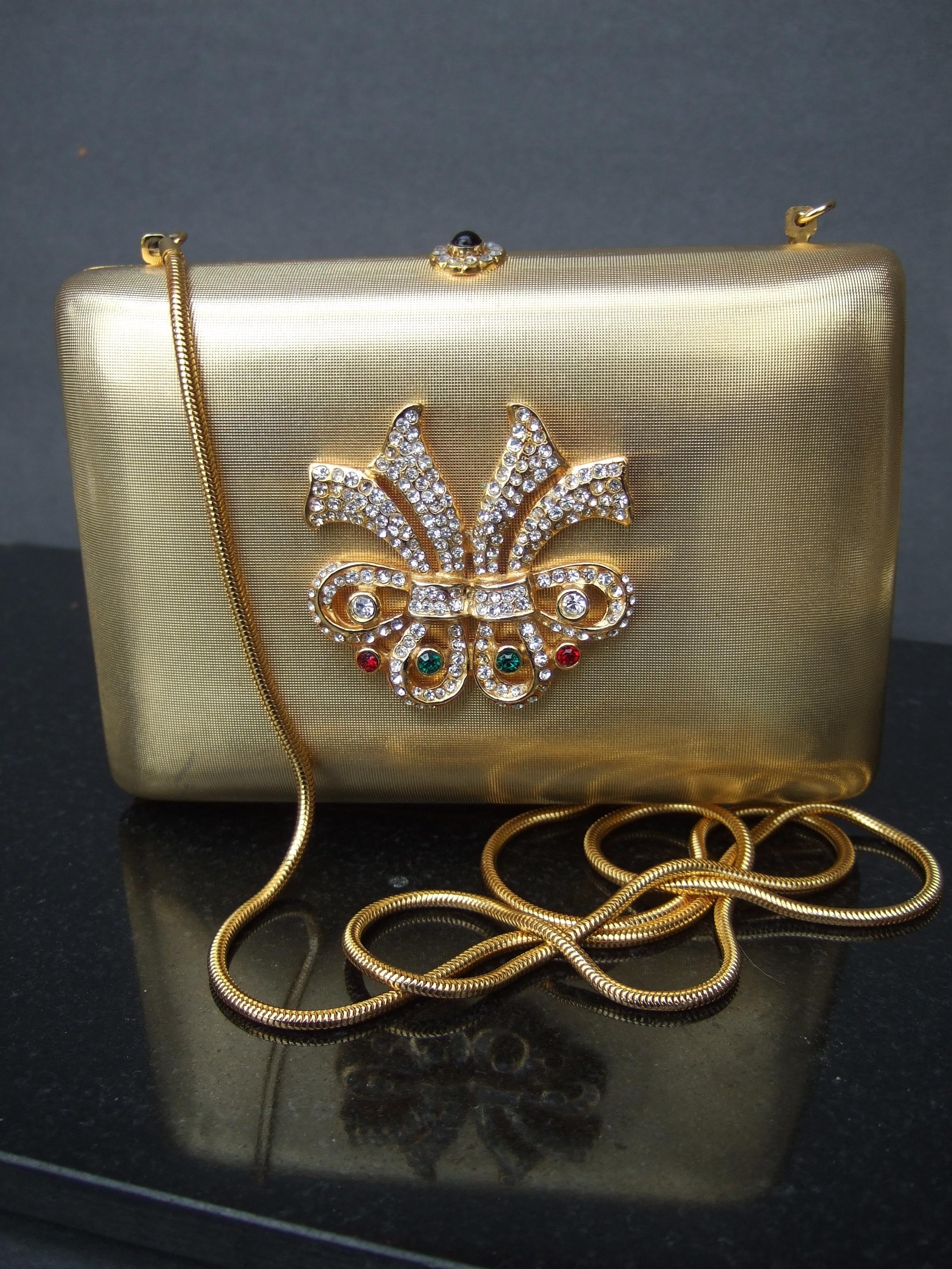 Saks Fifth Avenue Italian gilt metal crystal medallion minaudiere' evening bag c 1980s
The elegant gold metal evening bag has a satin matte finish. The front exterior panel
is adorned with a sinuous medallion encrusted with diamante & jewel crystals