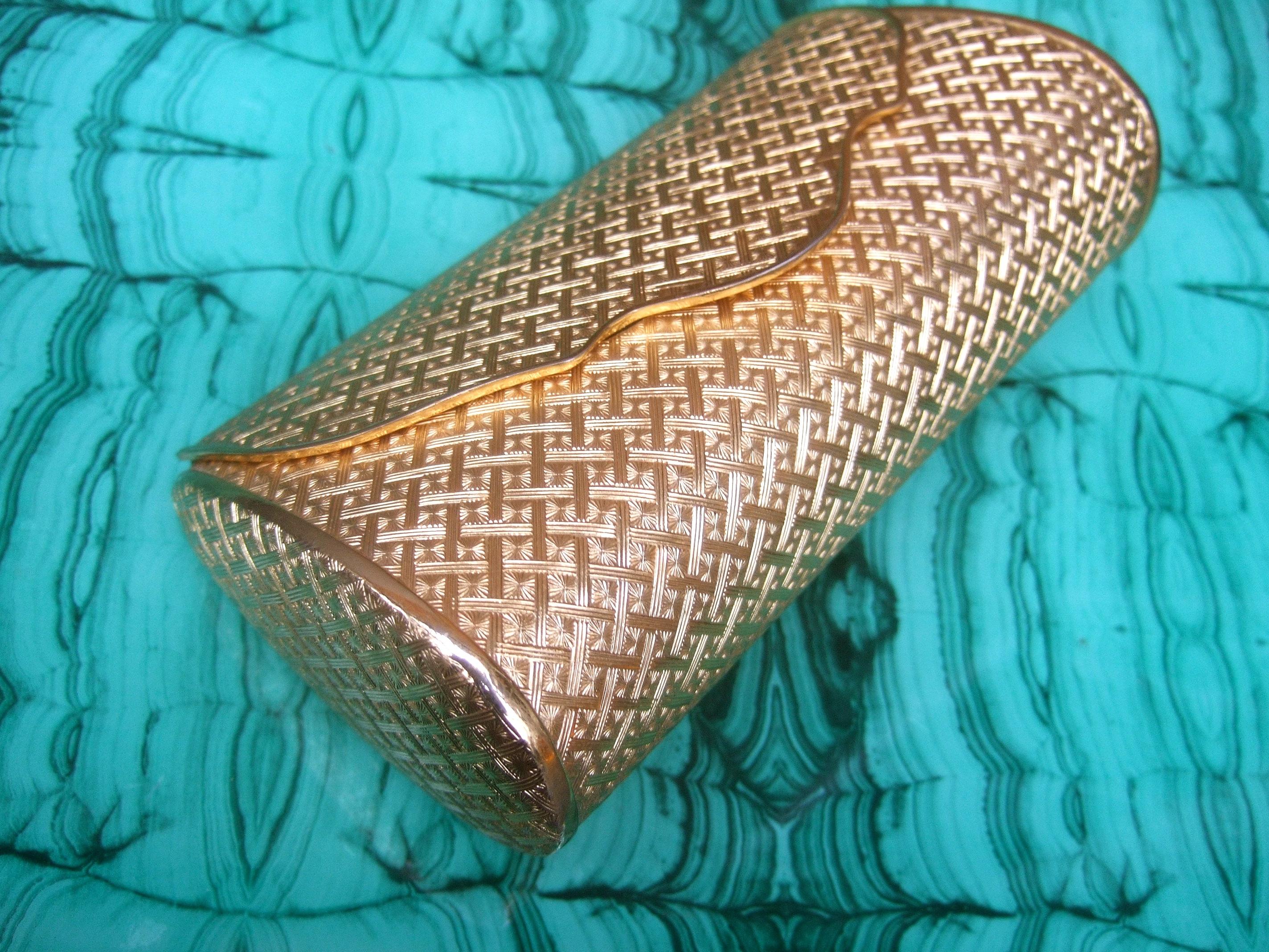 Saks Fifth Avenue Italian gilt metal minaudier' evening bag c 1970s
The sleek gold metal evening clutch is designed with impressed geometric designs throughout
A stationary vanity mirror is placed underneath the hinged lid cover 
Lined in golden