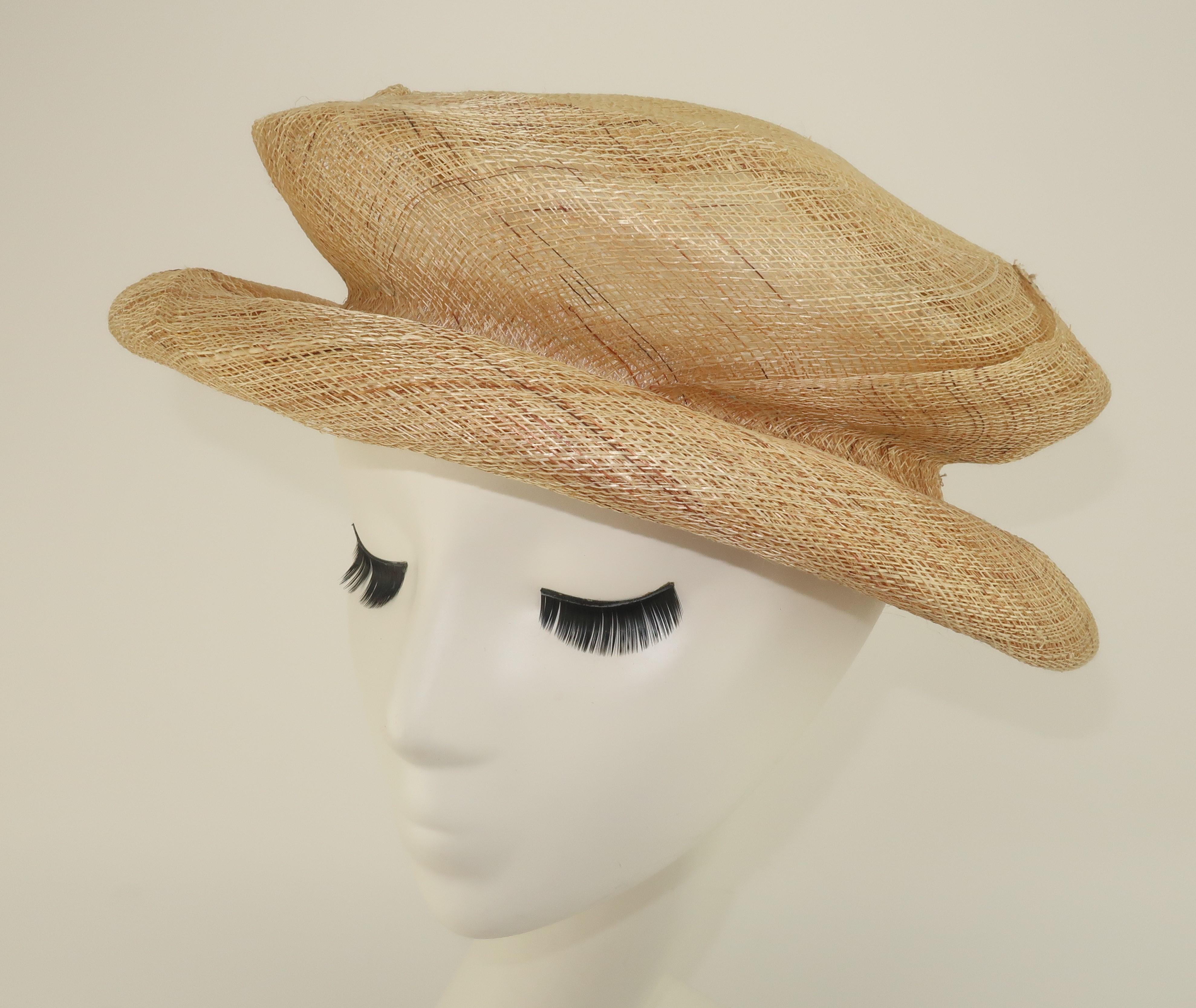 1990's Saks Fifth Avenue Italian straw hat with a nod to a Renaissance style silhouette.  The natural straw has a light open weave and is expertly constructed to provide a springy fit that can be worn with the rim pulled down or left up somewhat