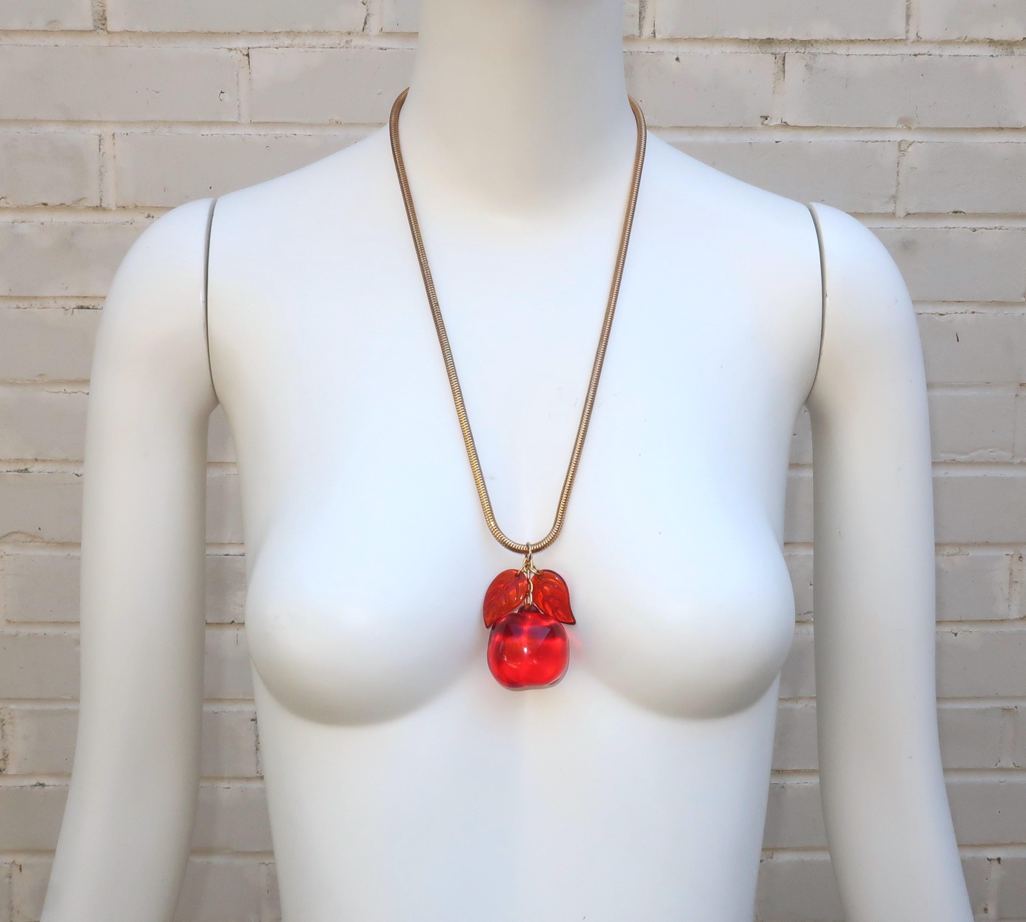 1970's lucite apple pendant necklace which retailed at Saks Fifth Avenue and may be a Les Bernard design.  This fun drop necklace has a pop art appeal with a heavy weight gold tone serpentine chain suspending a chunky lucite apple and articulated