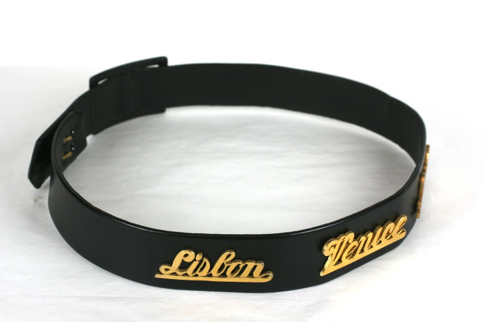Novelty travel motif belt 1950s of black kid leather, with gilt filigree wording of European cities including Lisbon, Venice, London, Rome, and Paris .  1950's USA. 
24
