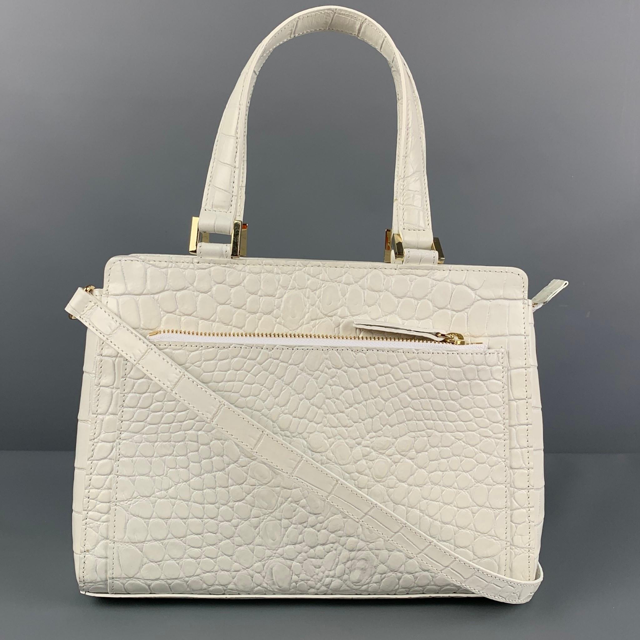 SAKS FIFTH AVENUE handbag comes in a white embossed leather featuring top handles, gold tone hardware, detachable crossbody strap, and a top zipper closure. Made in Italy. 

New With Tags. 

Measurements:

Length: 10.5 in.
Width: 4 in.
Height: 8