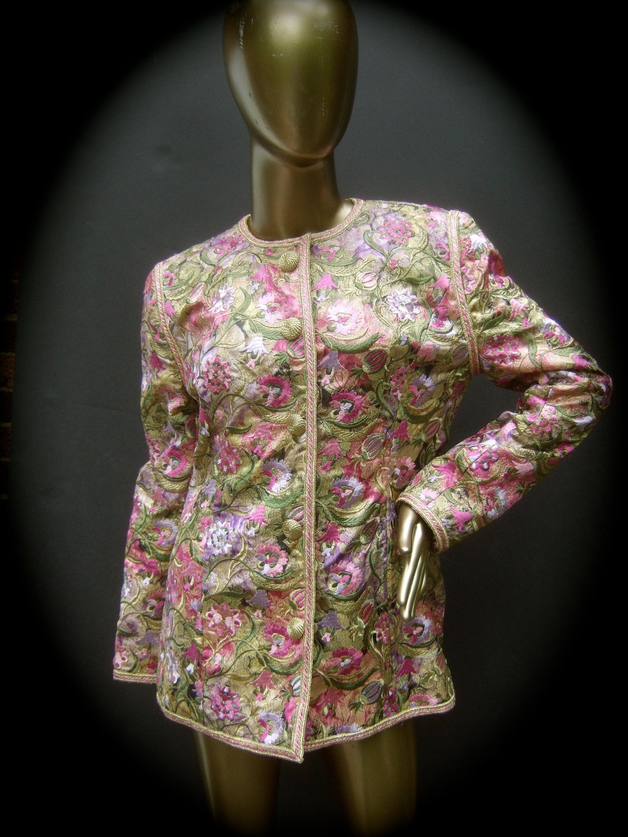 Saks Fifth Avenue Pastel floral embroidered brocade jacket by Victor Costa c 1980s

The elegant brocade Nehru style structured jacket is embellished with a collection of pink and lavender embroidered flowers; accented with green embroidered leaves