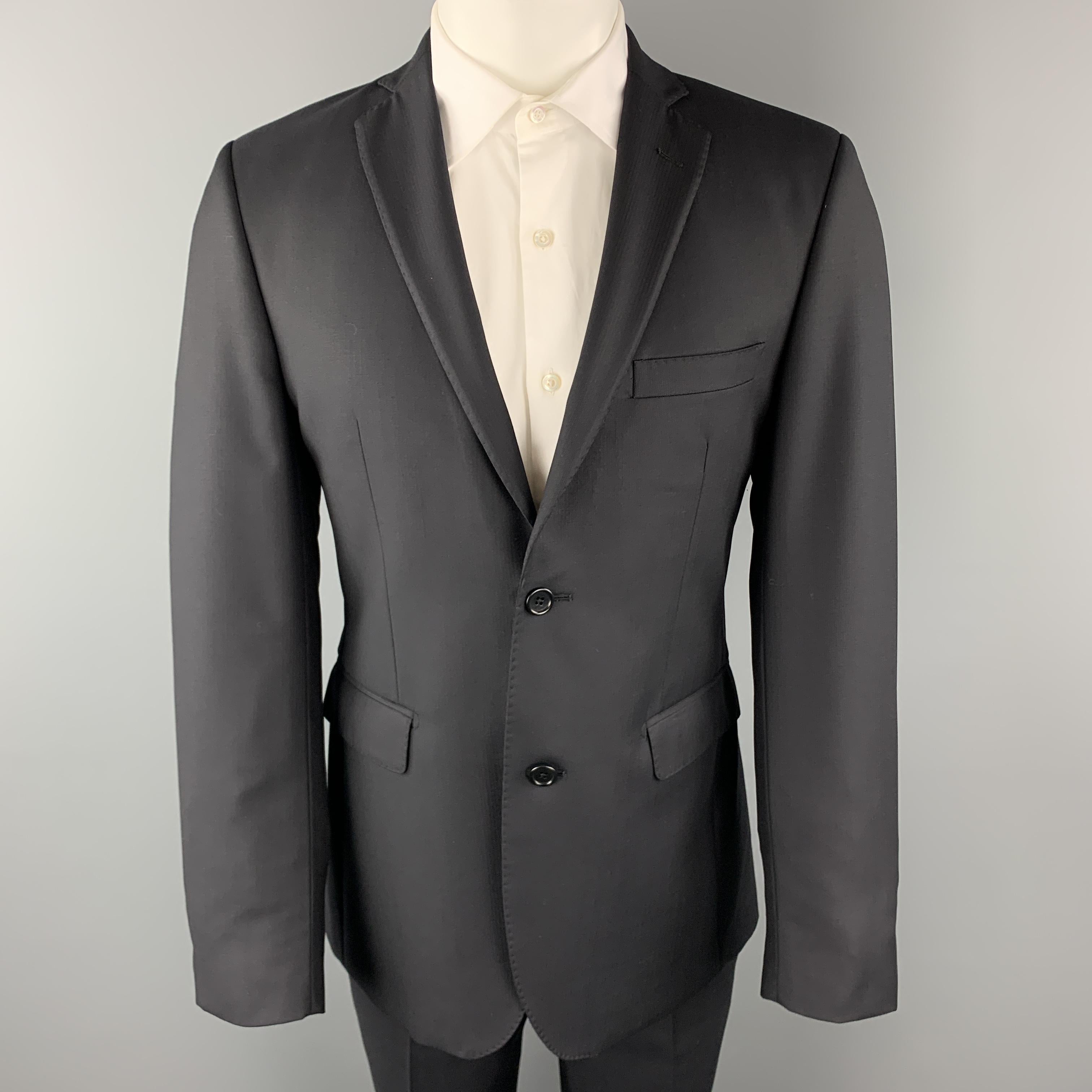 SAKE FIFTH AVENUE suit comes in black micro-herringbone ERMENEGILDO ZEGNA wool and includes a single breasted, two button sport coat with a notch lapel and matching flat front trousers. Made in Italy.

Excellent Pre-Owned Condition.
Marked: US