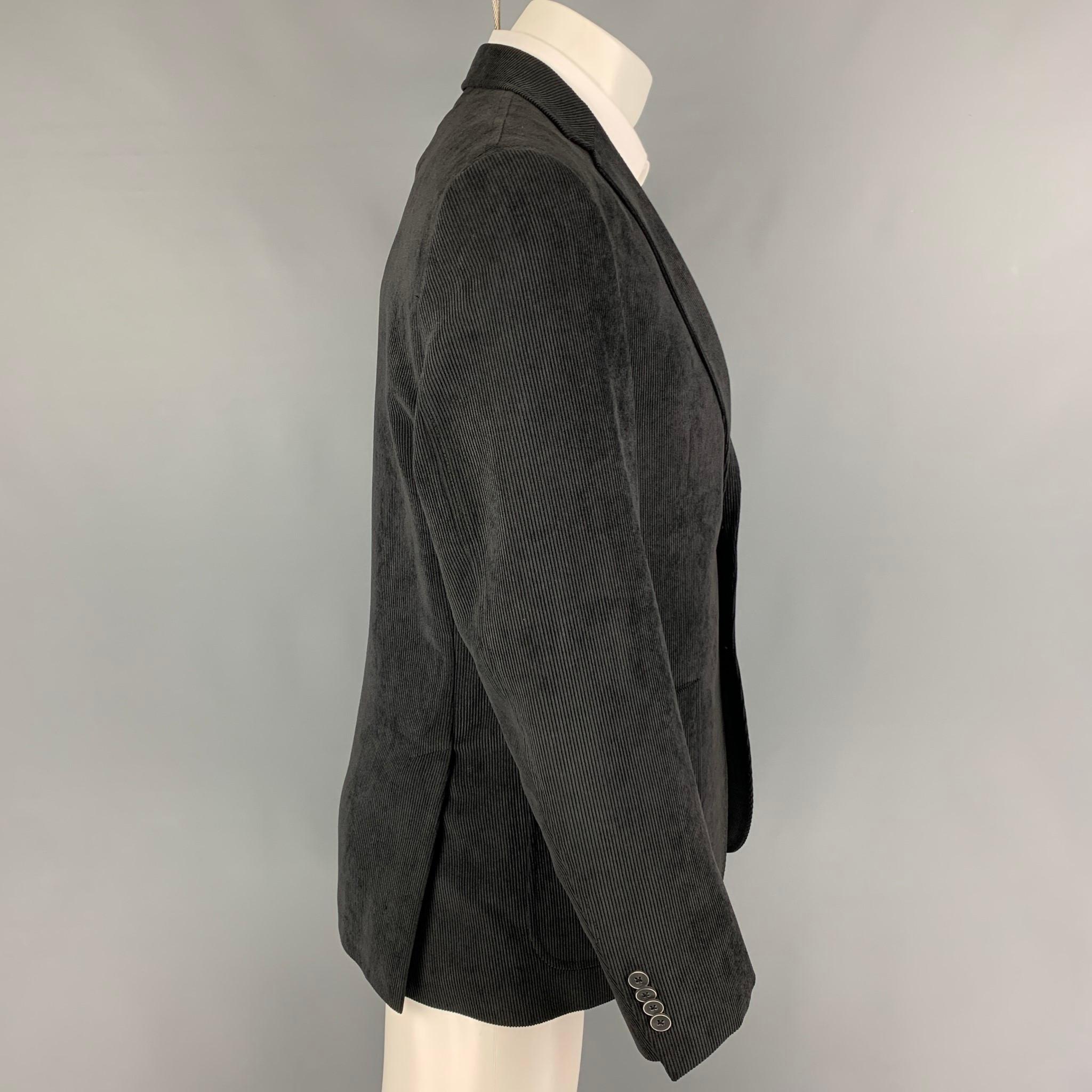 SAKS FIFTH AVENUE 'BLACK' sport coat comes in a slate corduroy polyester / polyamide with a full liner featuring a notch lapel, patch pockets, and a double button closure. 

Very Good Pre-Owned Condition.
Marked: 40 R
Original Retail Price: