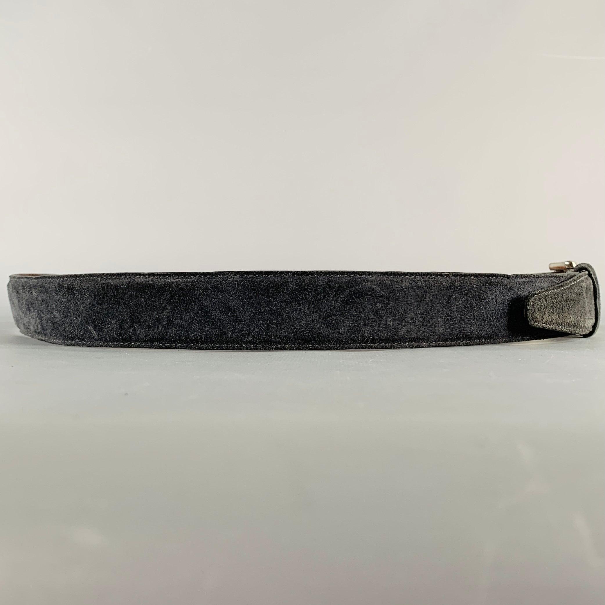 SAKS FIFTH AVENUE belt
in a navy suede featuring a silver tone metal buckle closure. Made in USA of European suede.Very Good Pre-Owned Condition. Minor marks. 

Marked:   456802-42Length: 49 inches Width: 1.25 inches Fits: 40 inches  - 44 inches