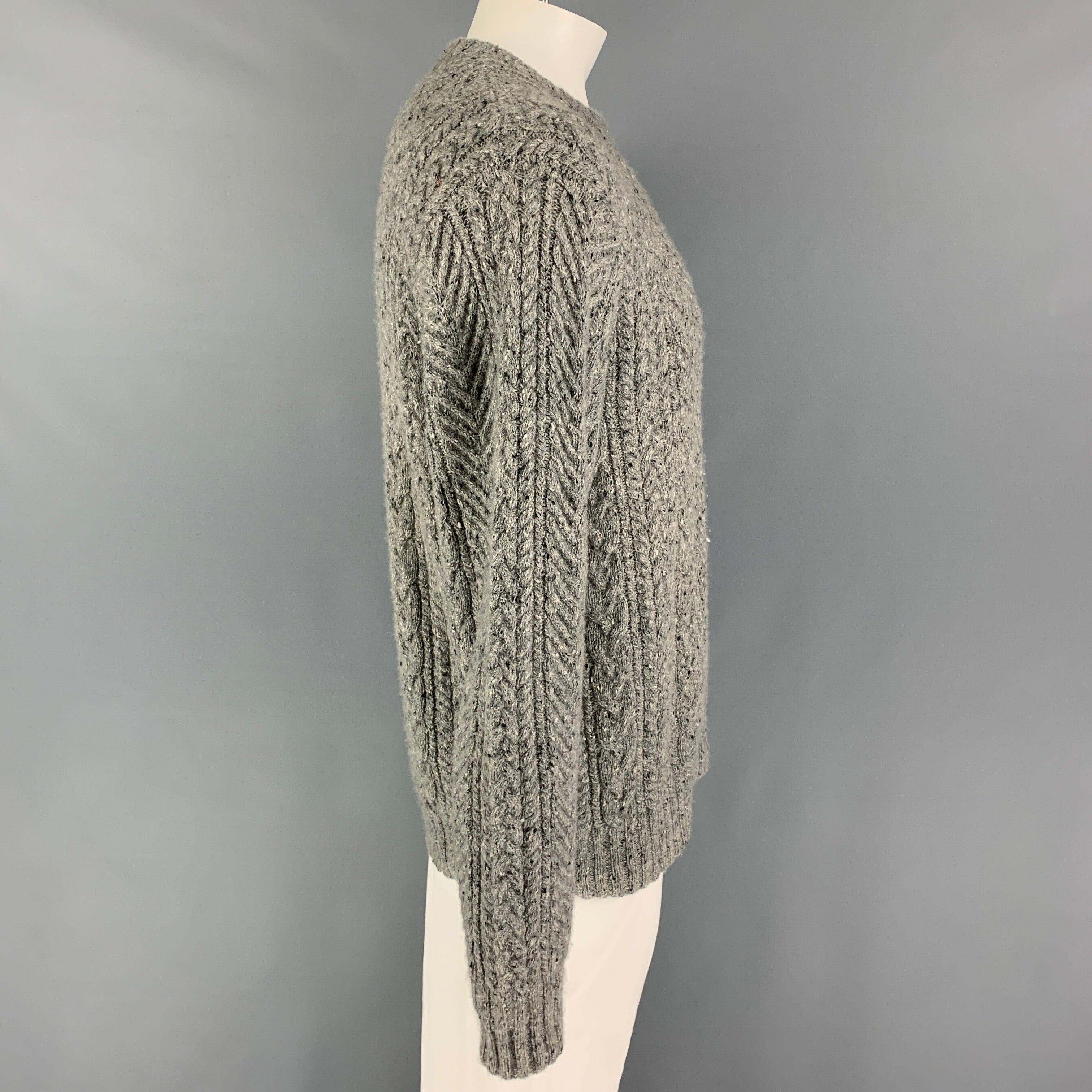 SAKS FITFH AVENUE sweater comes in a grey cable knit cashmere featuring a crew-neck.
Excellent
Pre-Owned Condition.  

Marked:   L  

Measurements: 
 
Shoulder: 19 inches Chest: 44 inches Sleeve: 27 inches Length: 29 inches 
  
  
 
Reference: