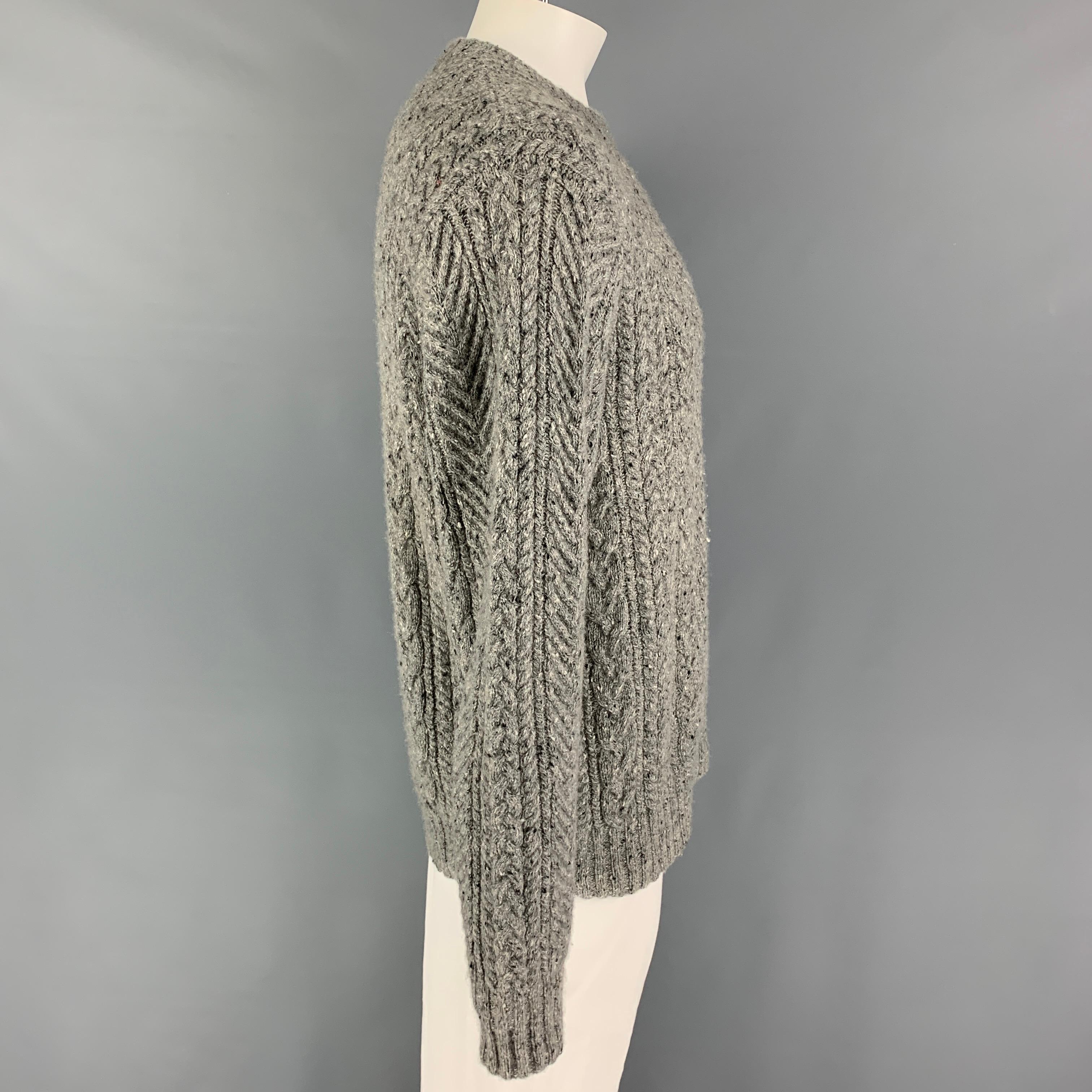 SAKS FITFH AVENUE sweater comes in a grey cable knit cashmere featuring a crew-neck. 

Excellent Pre-Owned Condition.
Marked: L

Measurements:

Shoulder: 19 in.
Chest: 44 in.
Sleeve: 27 in.
Length: 29 in.