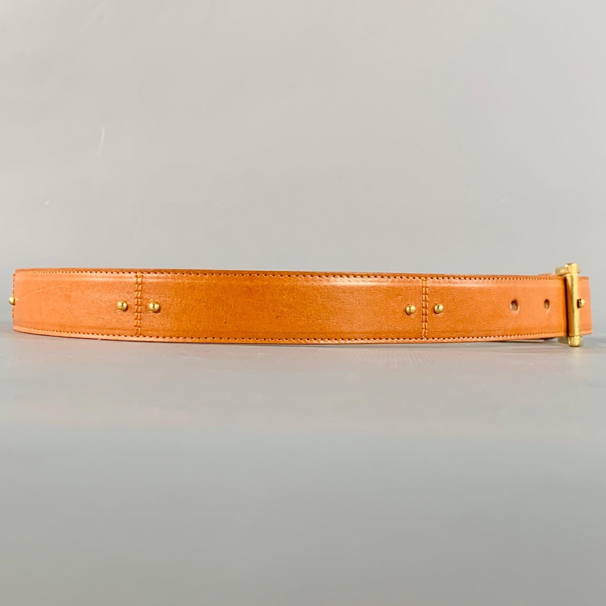 SAKS FIFTH AVENUE
belt in a camel colored leather featuring a gold tone metal studded design, and gold tone metal buckle closure. Made in Italy.Excellent Pre-Owned Condition.  

Marked:   MLength: 32 inches Width: 0.75 inches Fits: 25 inches  - 29