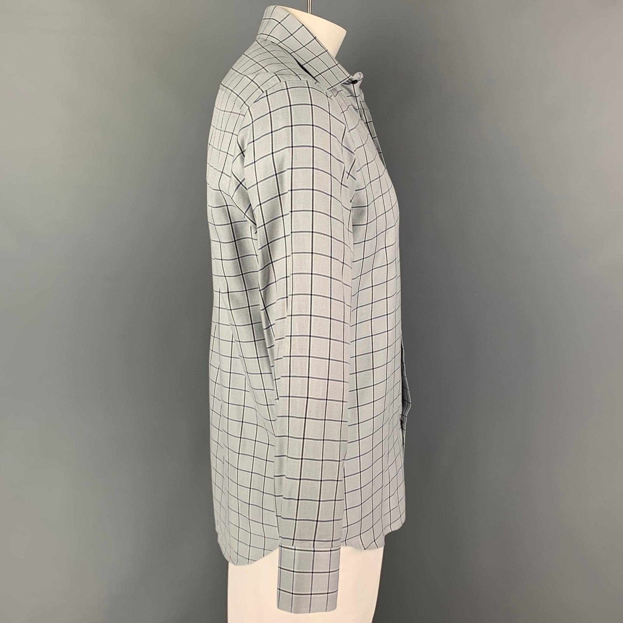 SAKS FIFTH AVENUE long sleeve shirt comes in a blue plaid cotton featuring a spread collar and a button up closure.
Very Good
Pre-Owned Condition. 

Marked:   16R 

Measurements: 
 
Shoulder: 18.5 inches Chest: 44 inches Sleeve: 25 inches Length: 32