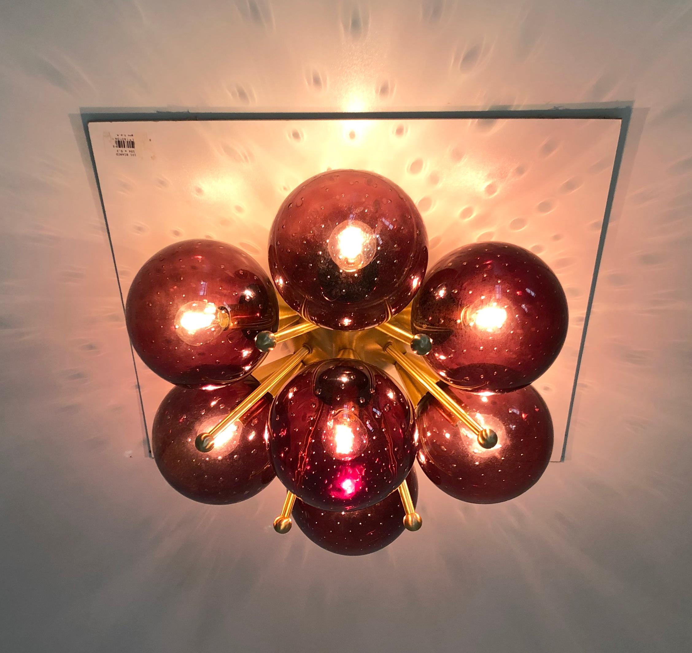 Italian flush mount with Murano glass globes mounted on solid brass frame 
Designed by Fabio Bergomi / Made in Italy 7 lights / E12 or E14 type / max 40W each 
Diameter: 22 inches / Height: 11 inches 
Order only / This item ships from Italy 
Order